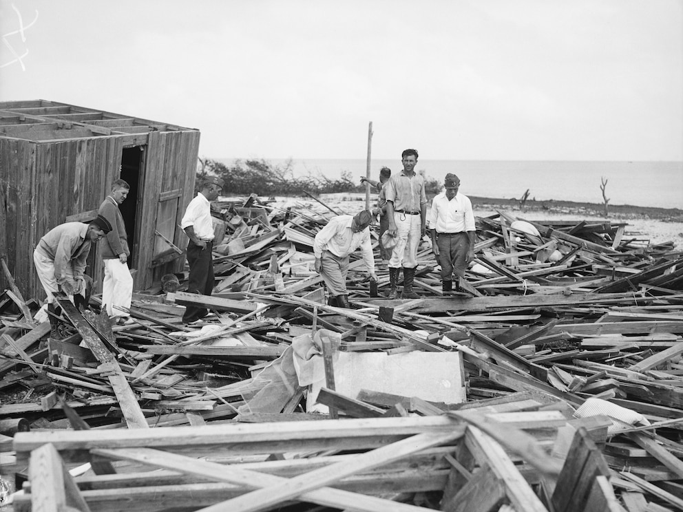 PHOTO: Men Search Hurricane Debris