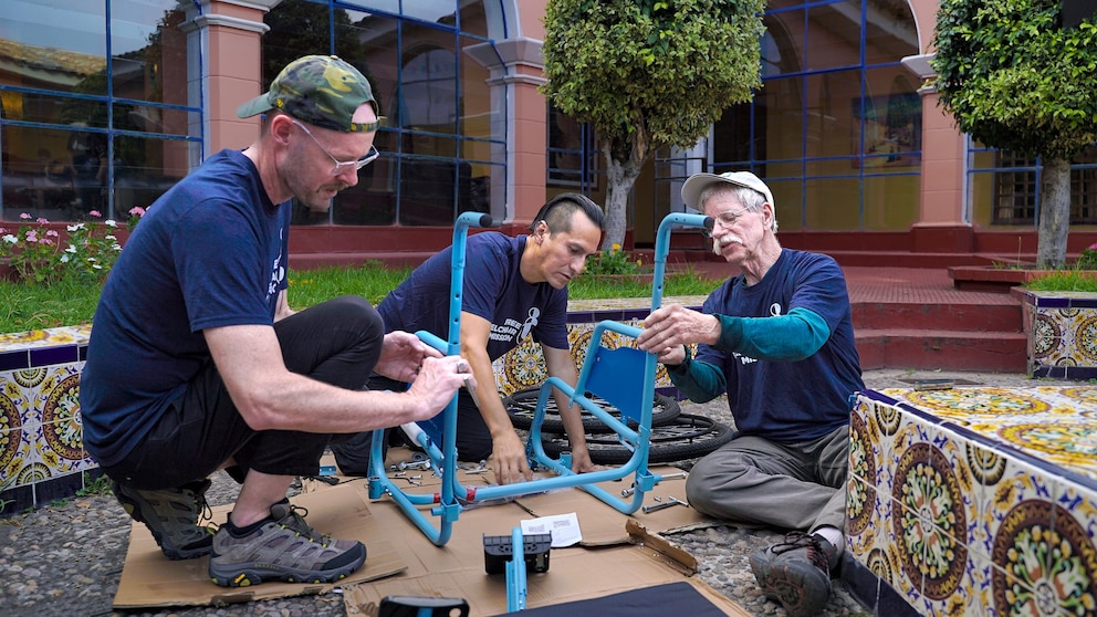 PHOTO: Don Schoendorfer, Free Wheelchair Mission founder and president, (R), assembles a wheelchair with Clever Sobrino and Pastor Taylor Barriger, in Peru.