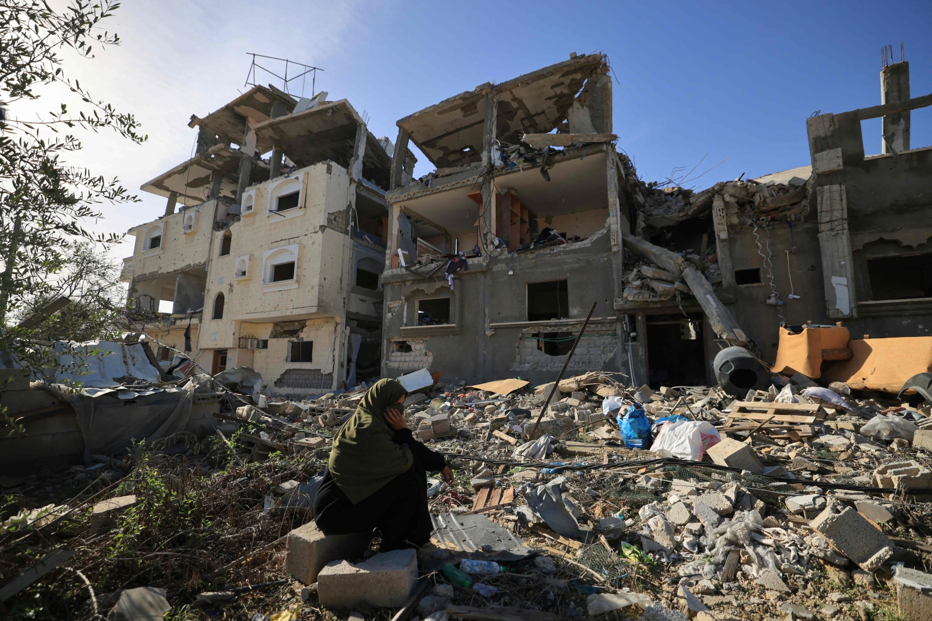 PHOTO: A Palestinian woman sits amid the destruction as people return to inspect the damage to their homes from Israeli bombardment in the southern Gaza Strip on Nov. 24, 2023, following the start of a four-day ceasefire between Israel and Hamas.