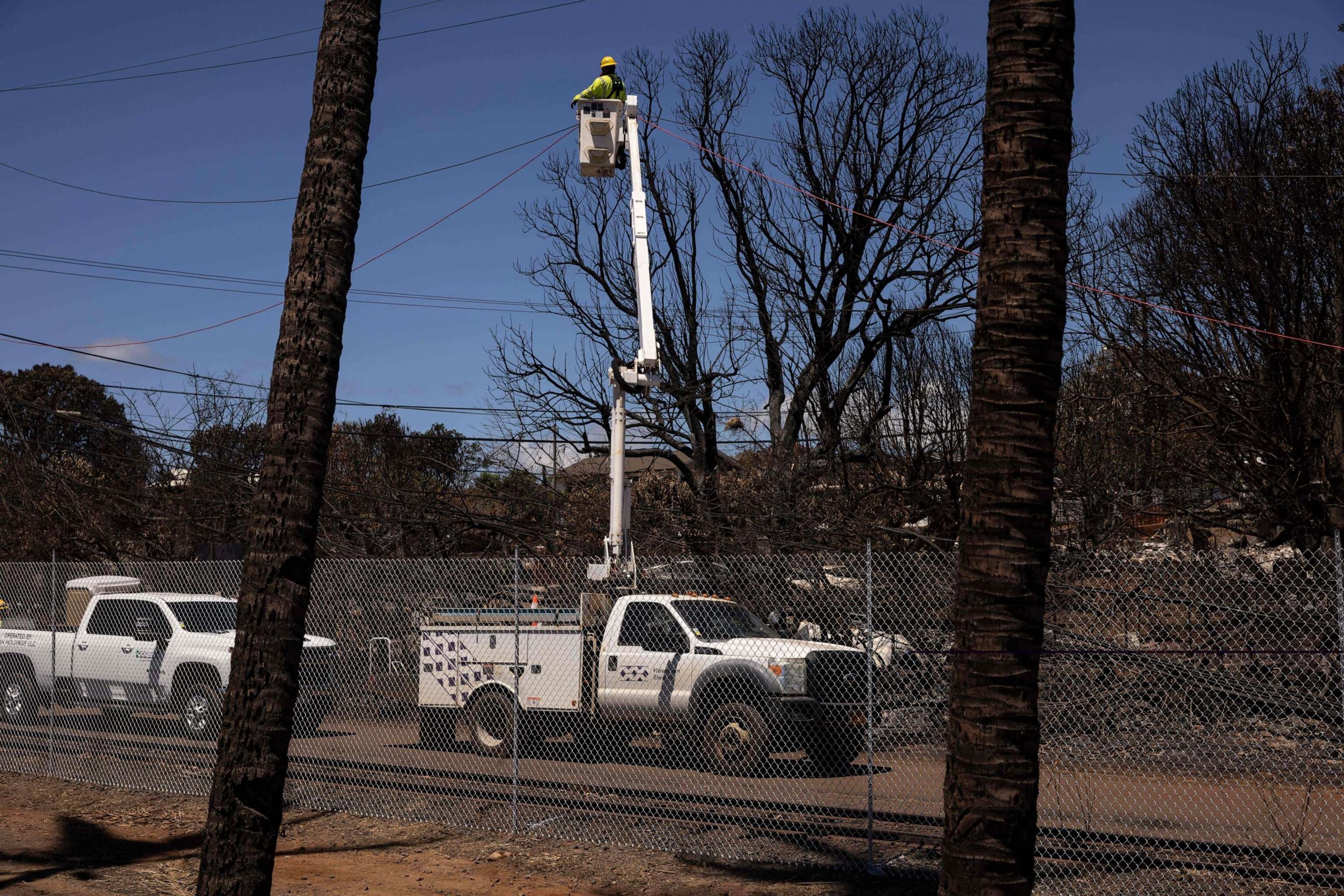 PHOTO: A Hawaiian Electric employee repairs power lines in the aftermath of the Maui Fires in Lahaina, West Maui, Hawaii, Aug. 17, 2023.