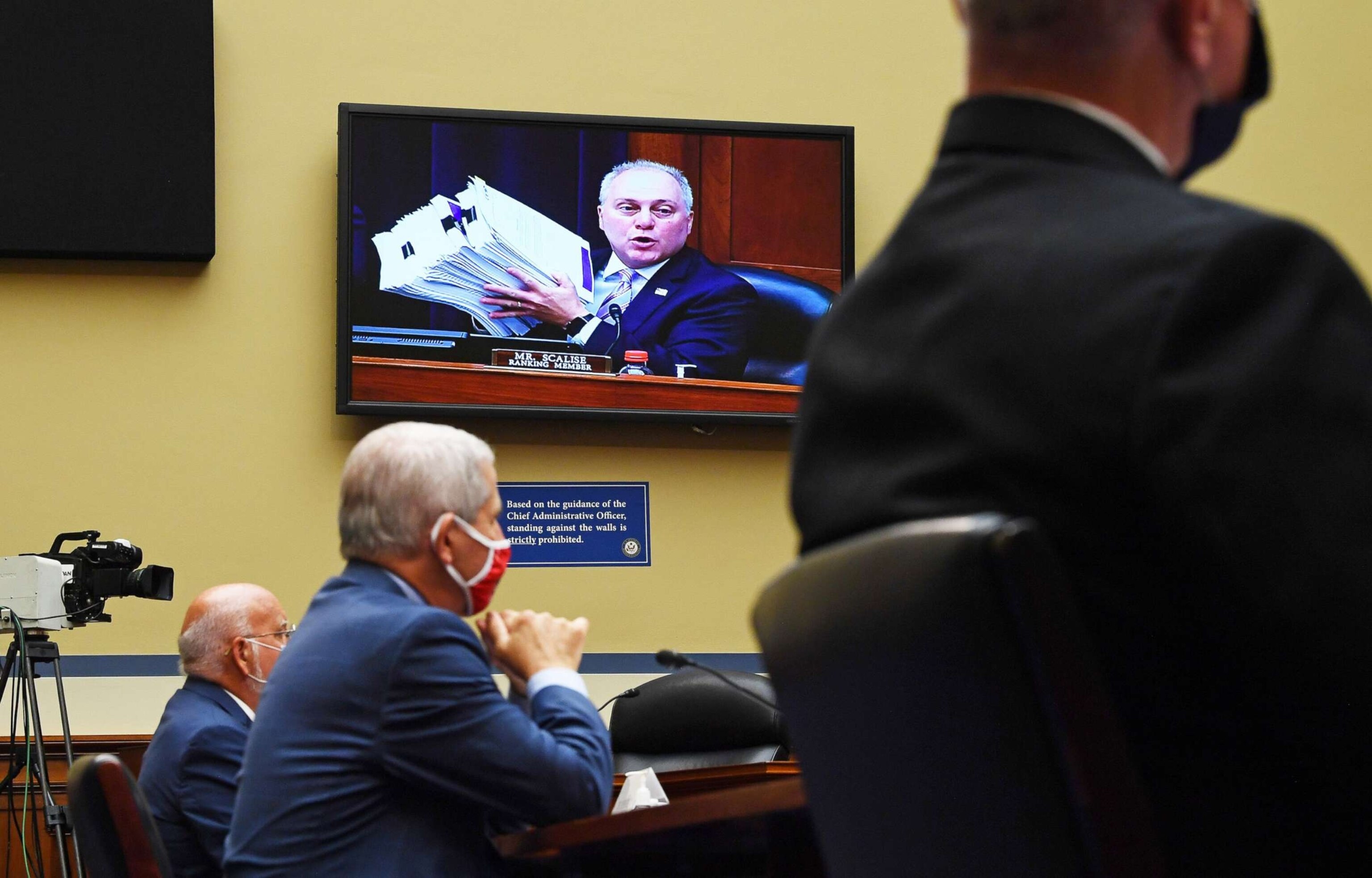 PHOTO: Rep. Steve Scalise is seen on a monitor holding up a stack of documents as  Dr. Anthony Fauci testifies at a House Subcommittee on the Coronavirus Crisis hearing on Capitol Hill, July 31, 2020.