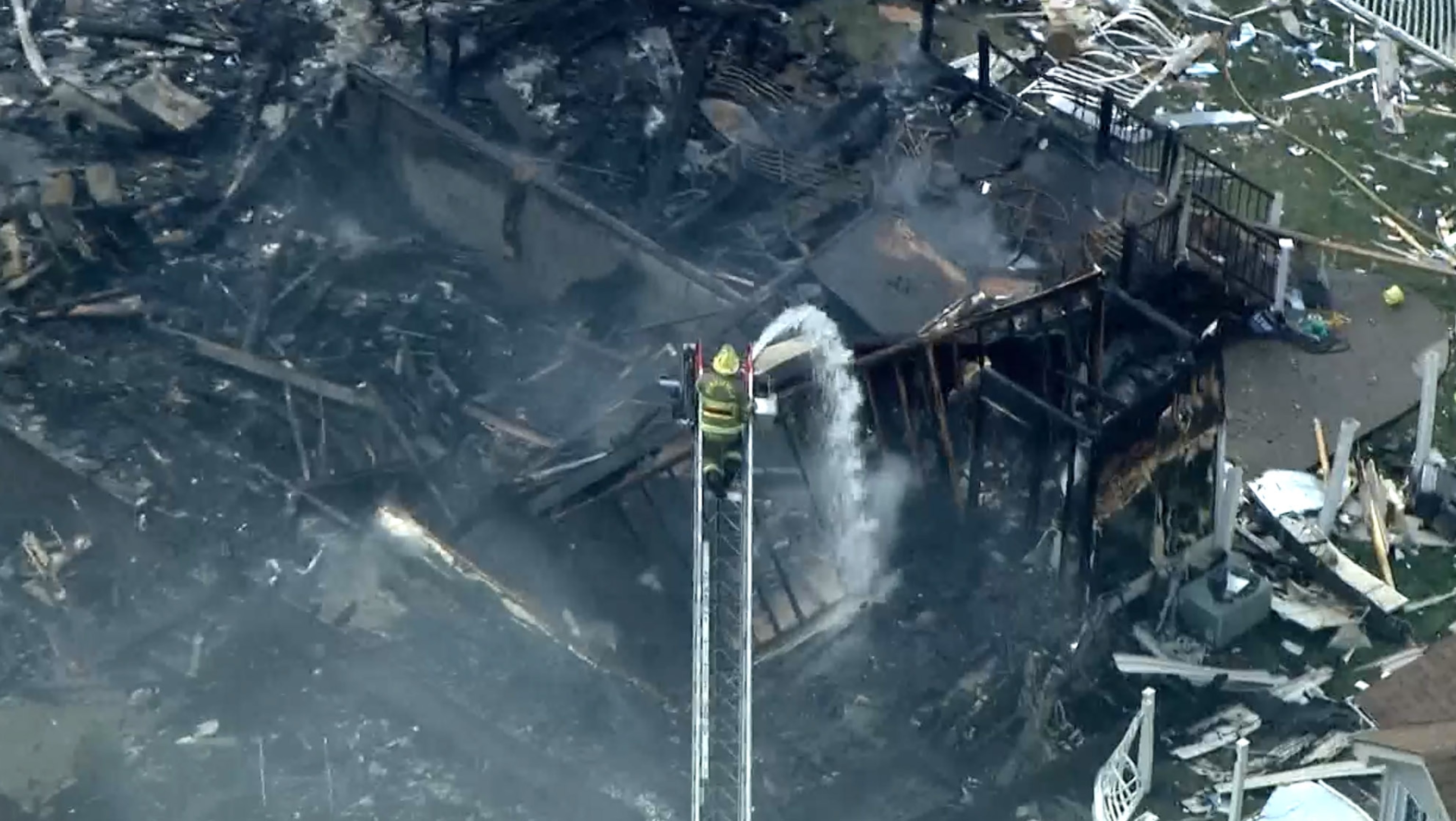 PHOTO: In this screen grab from a video, a firefighter works to put out a fire after a house explosion in Plum, Pa., on Aug. 12, 2023.