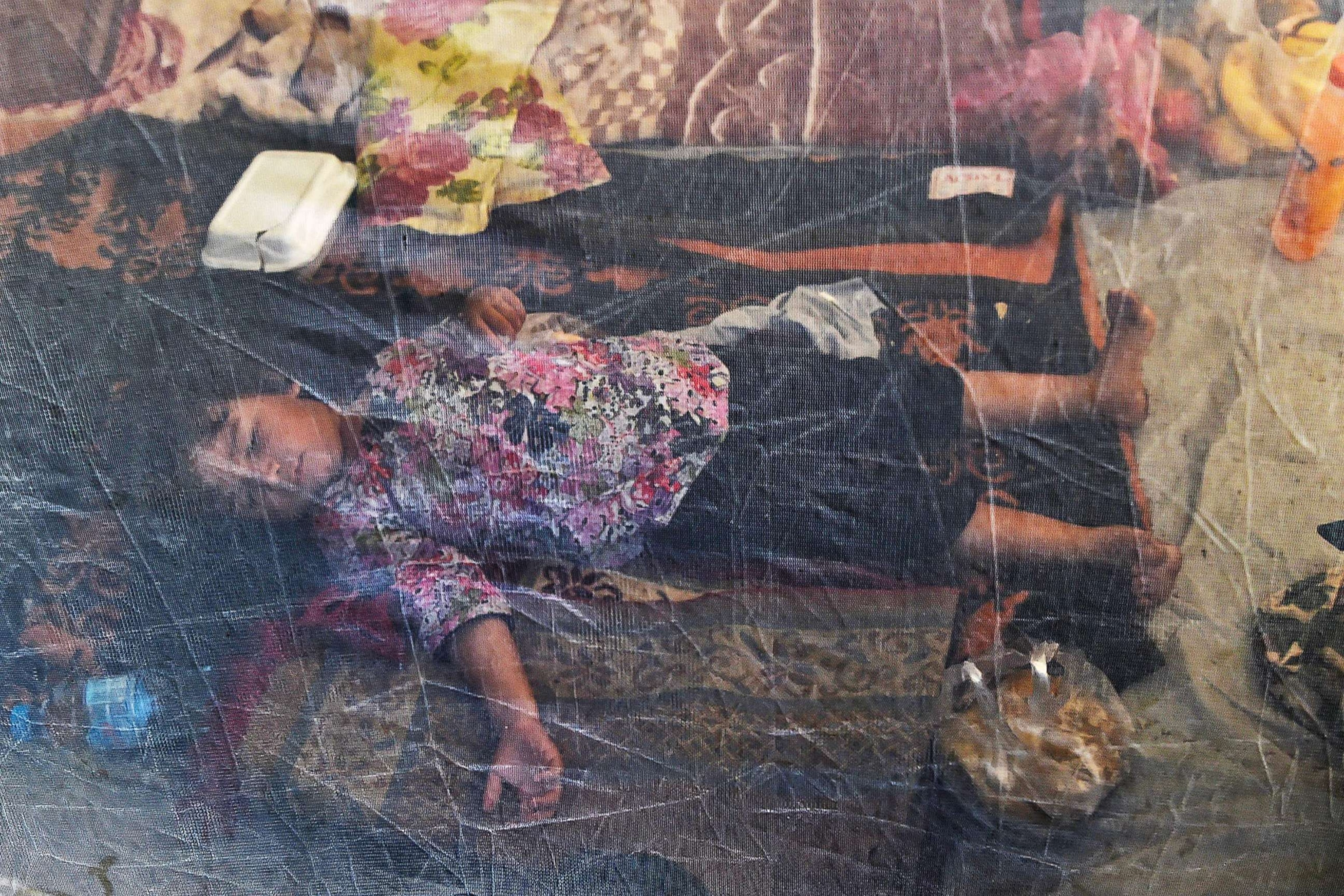 PHOTO: A displaced child sleeps under a mosquito net in a tent at a makeshift camp after fleeing from flood hit home following heavy monsoon rains in Charsadda district of Khyber Pakhtunkhwa, Aug. 29, 2022. 