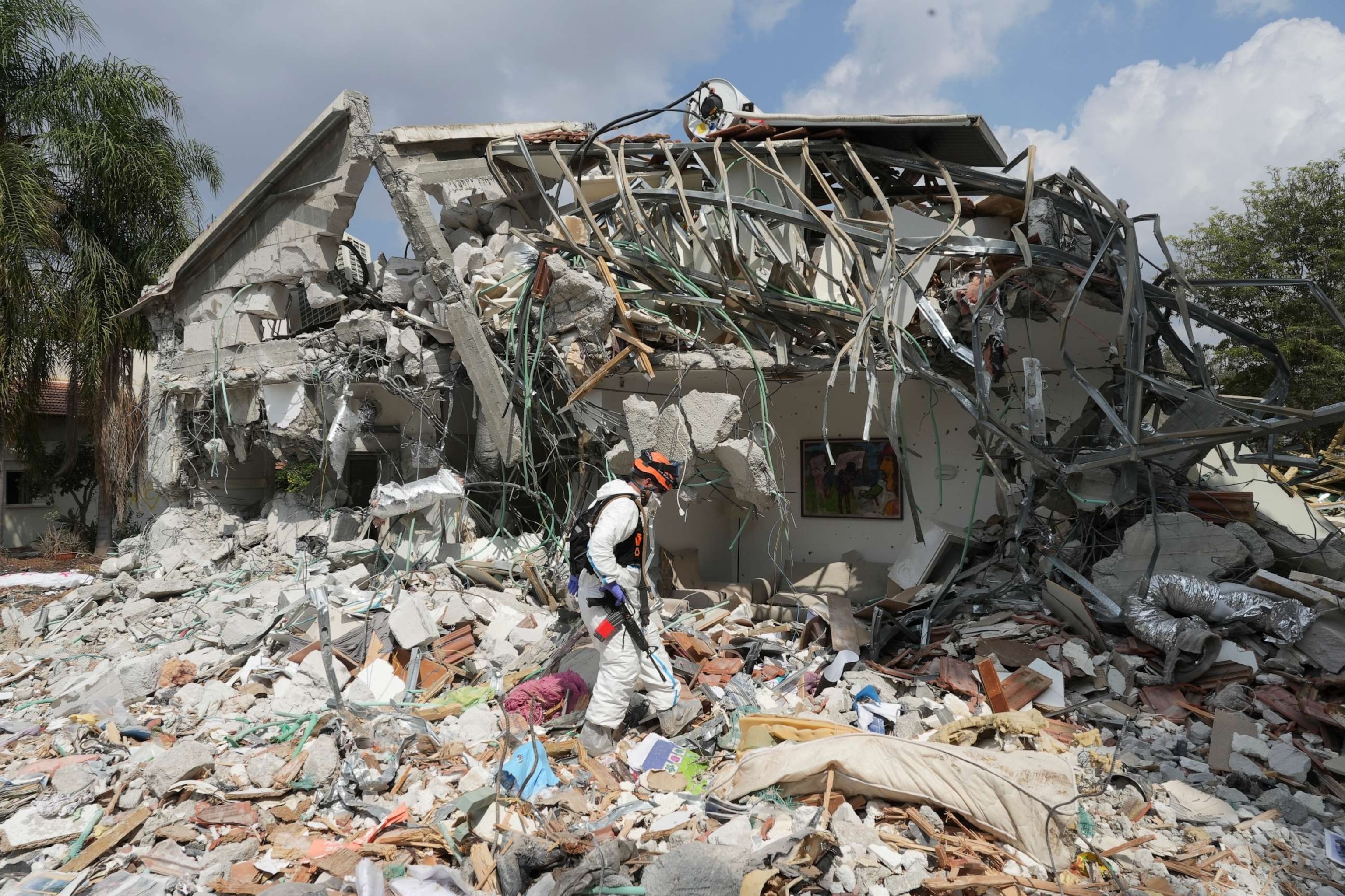 PHOTO: An Israeli soldier walks by a house destroyed by Hamas militants in Kibbutz Be'eri, Oct. 11, 2023.