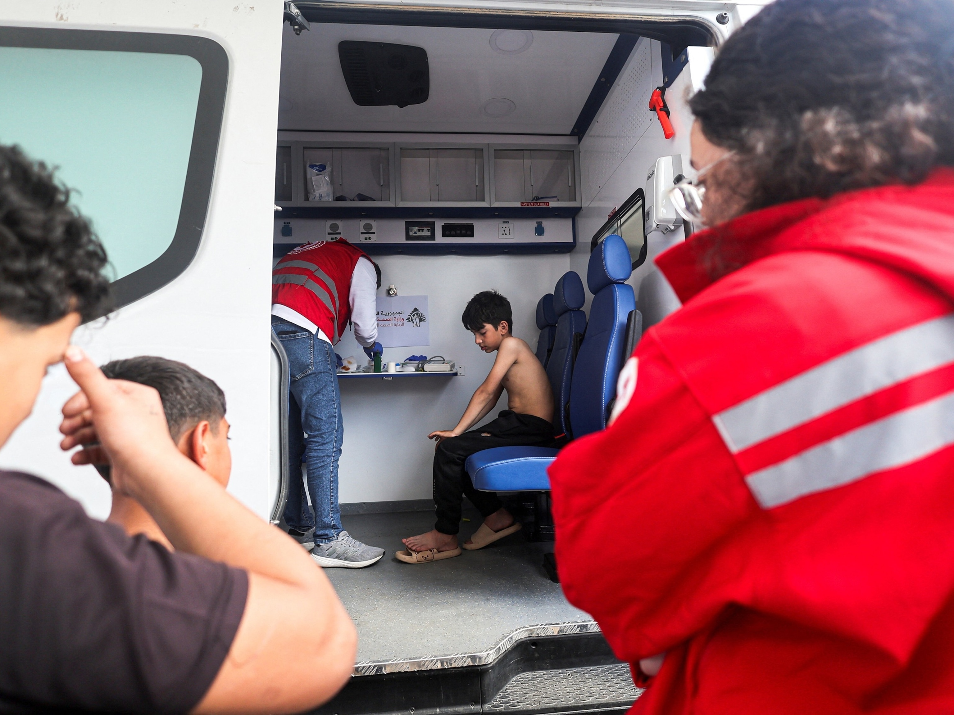 PHOTO: A member of the Lebanese Red Cross provides medical attention to a child at a medical aid point assisting displaced people following an escalation between Hezbollah and Israel in Beirut, Lebanon, March 16, 2026.