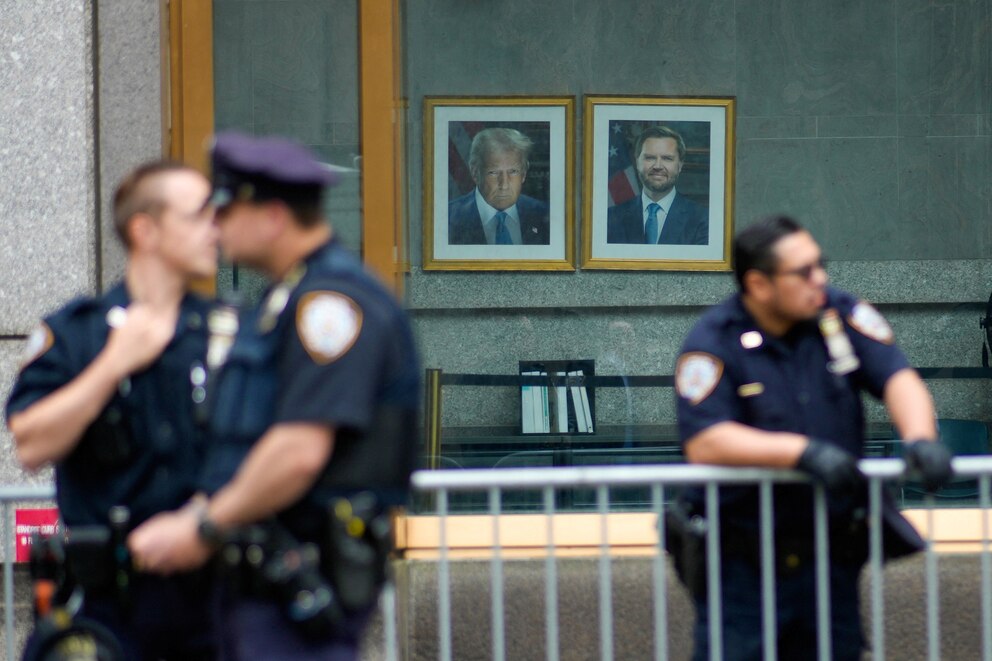 PHOTO: The portraits of President Donald Trump and Vice President JD Vance are displayed at the Ted Weiss Federal Building as members of the New York City Police Department (NYPD) stand in preparation for protests in New York., June 9, 2025.  