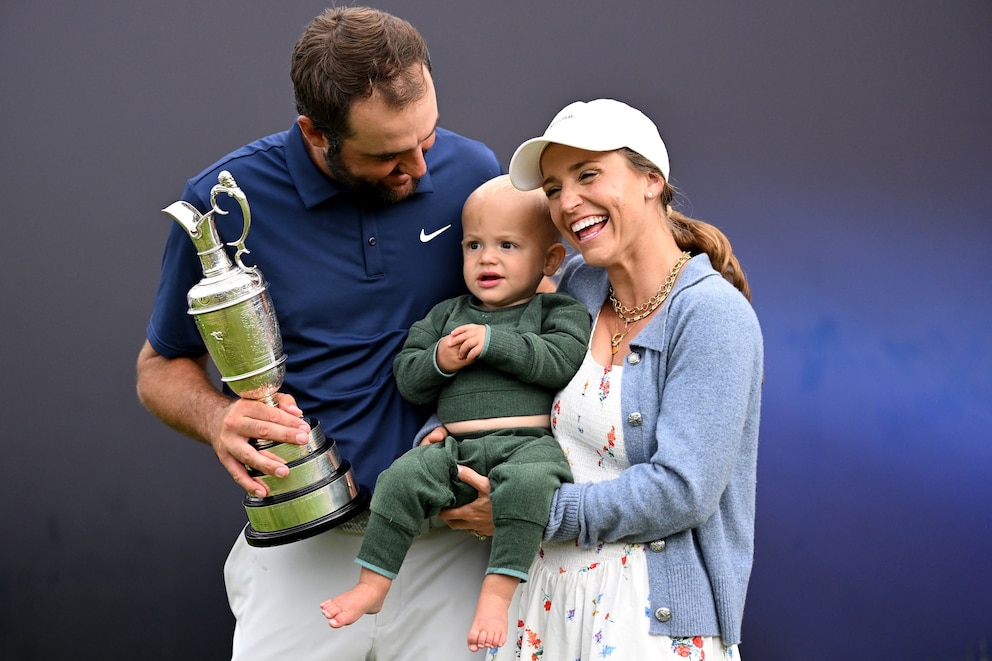 PHOTO: Scottie Scheffler of the United States celebrates victory on 18th green with his son Bennett Scheffler, wife Meredith Scheffler at The 153rd Open Championship at Royal Portrush Golf Club on July 20, 2025, in Portrush, Northern Ireland. 