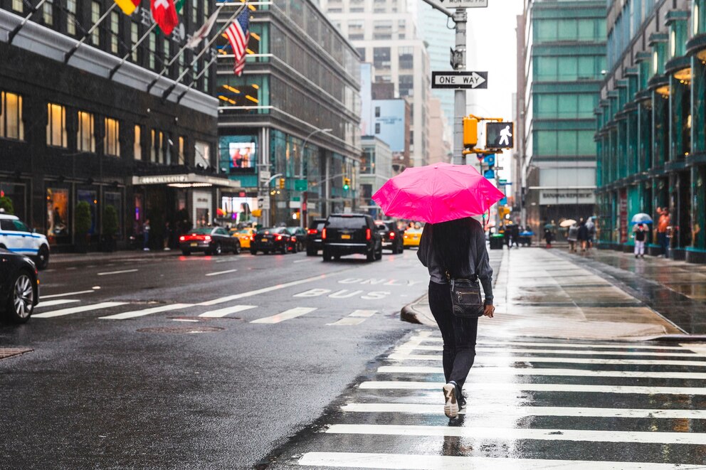 PHOTO: USA, New York, woman in the city on a rainy day