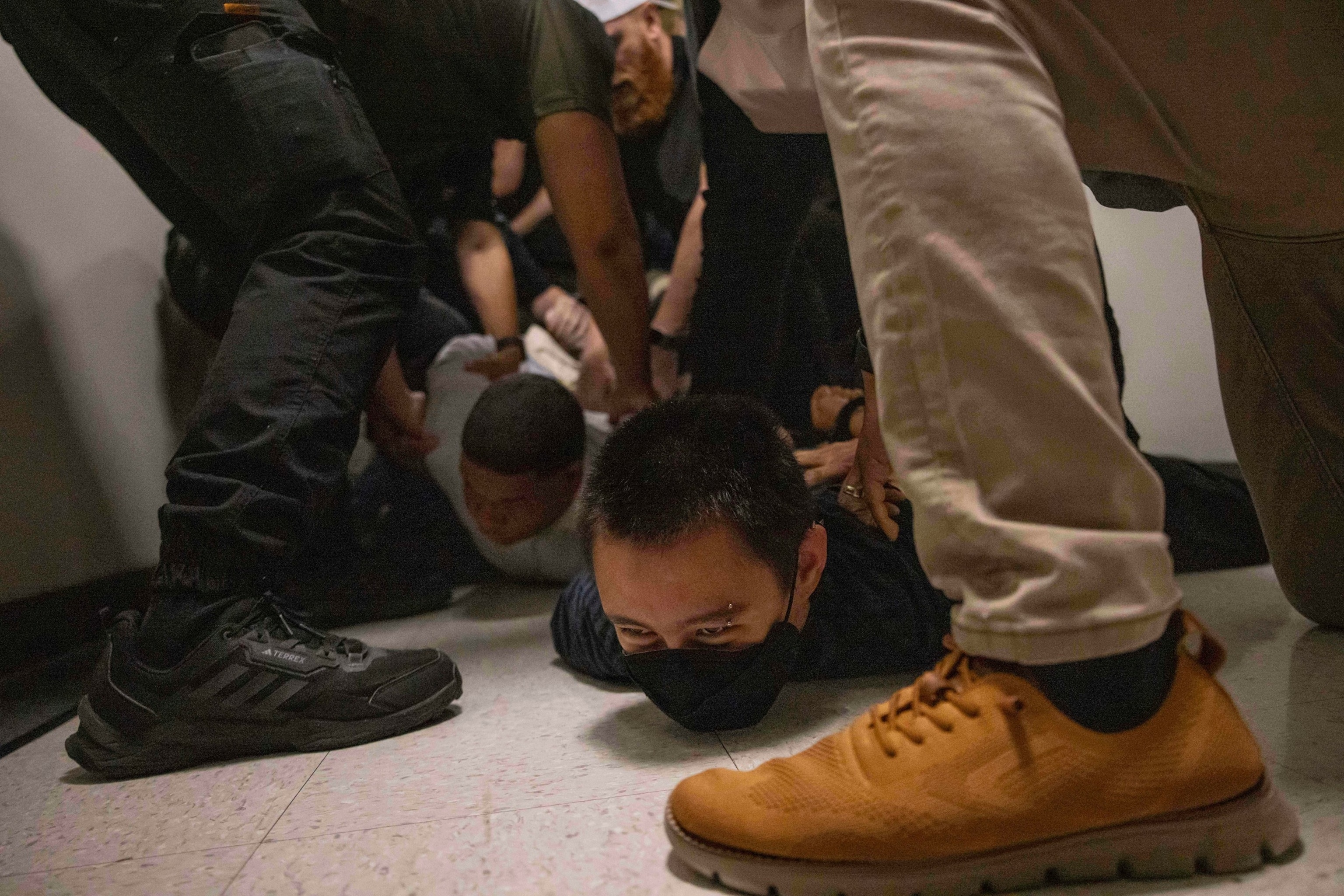 PHOTO: A Dominican man, left, and an activist, right, are detained by plain clothes officers with ICE agents after an immigration hearing at the Jacob K. Javitz Federal Building in New York, June 6, 2025.