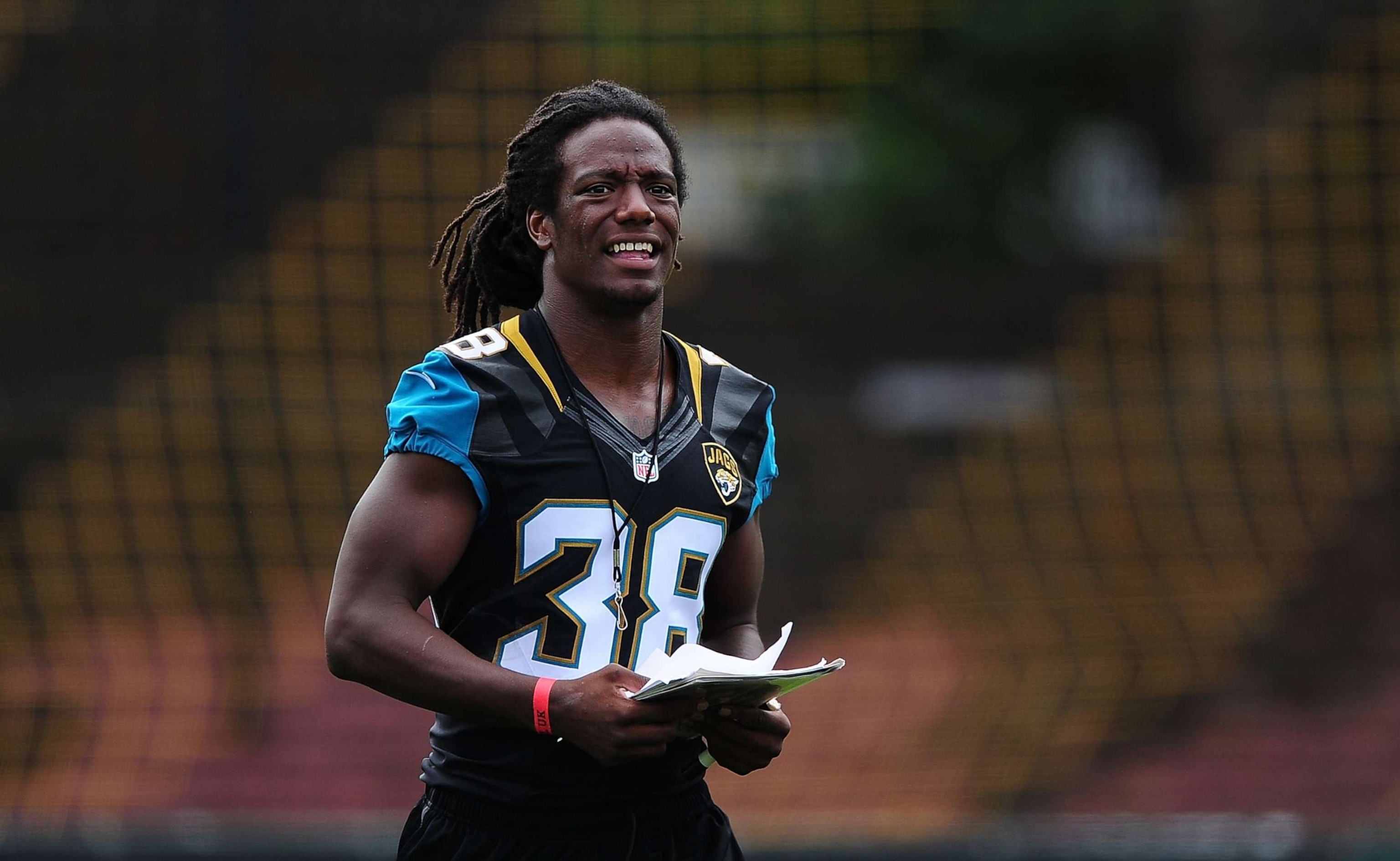 PHOTO: Sergio Brown of the Jacksonville Jaguars helps to coach a team of local school children during the NFL Launch of the Play 60 scheme at the Black Prince Community Hub, July 15, 2015, in London.