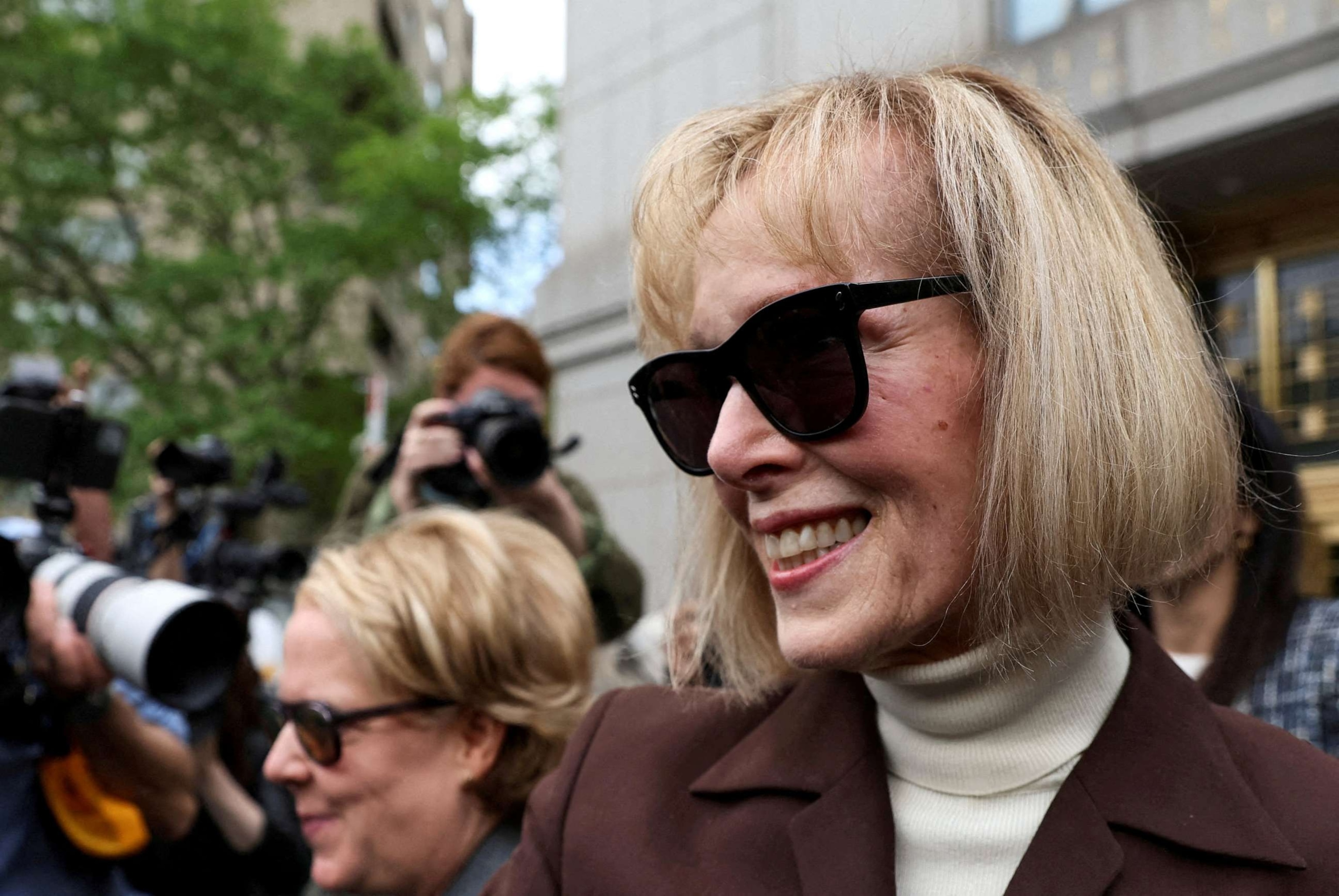 PHOTO: E. Jean Carroll reacts as she exits the Manhattan Federal Court following the verdict in the civil rape accusation case against former U.S. President Donald Trump, in New York City, May 9, 2023.