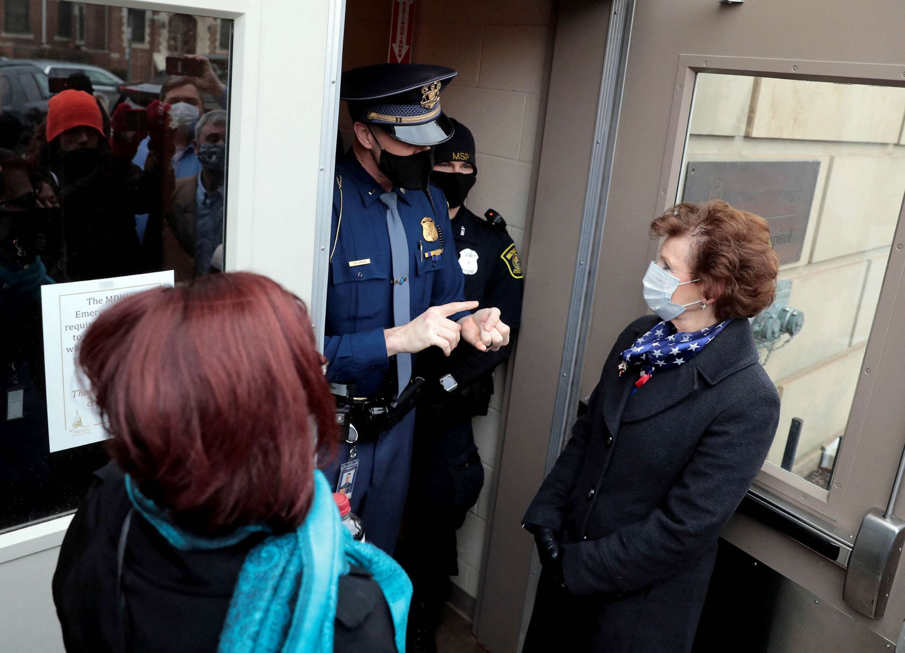 PHOTO: FILE - Michigan Rep. Daire Rendon and a group of Republican electors are refused entry by police into the State Capitol as the Michigan Electoral College meets to count their votes in Lansing, Mich., Dec. 14, 2020.