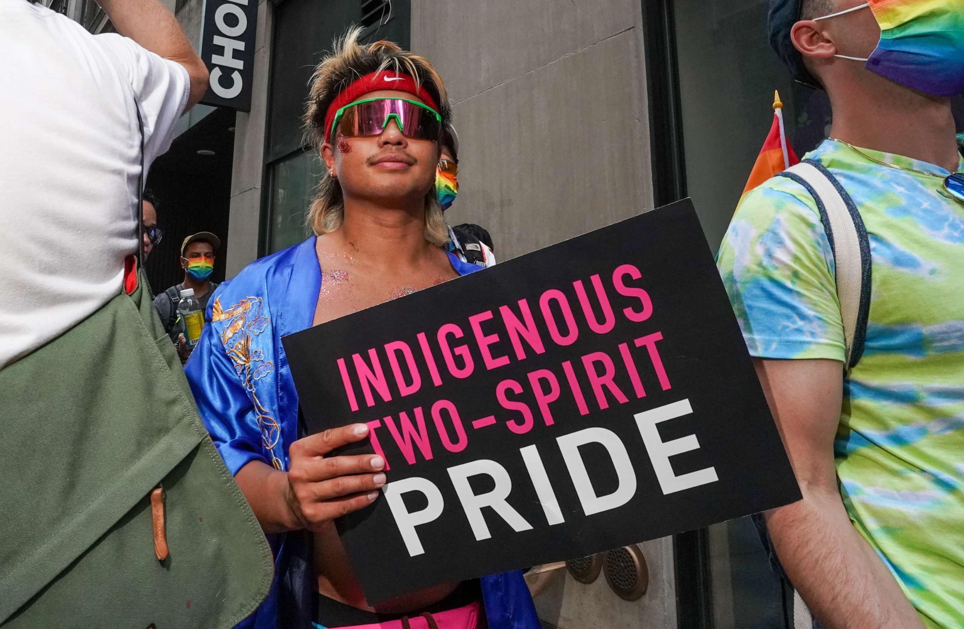 PHOTO: A person carries a sign that reads "Indigenous Two-Spirit Pride" during the Queer Liberation March on June 27, 2021, in New York City.