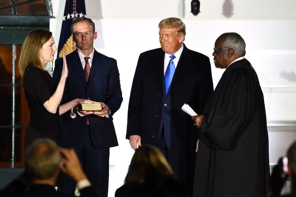 PHOTO: President Donald Trump watches as Justice Clarence Thomas swears in Judge Amy Coney Barrett as a Supreme Court Associate Justice, flanked by her husband Jesse M. Barrett, during a ceremony on the South Lawn of the White House, Oct. 26, 2020.