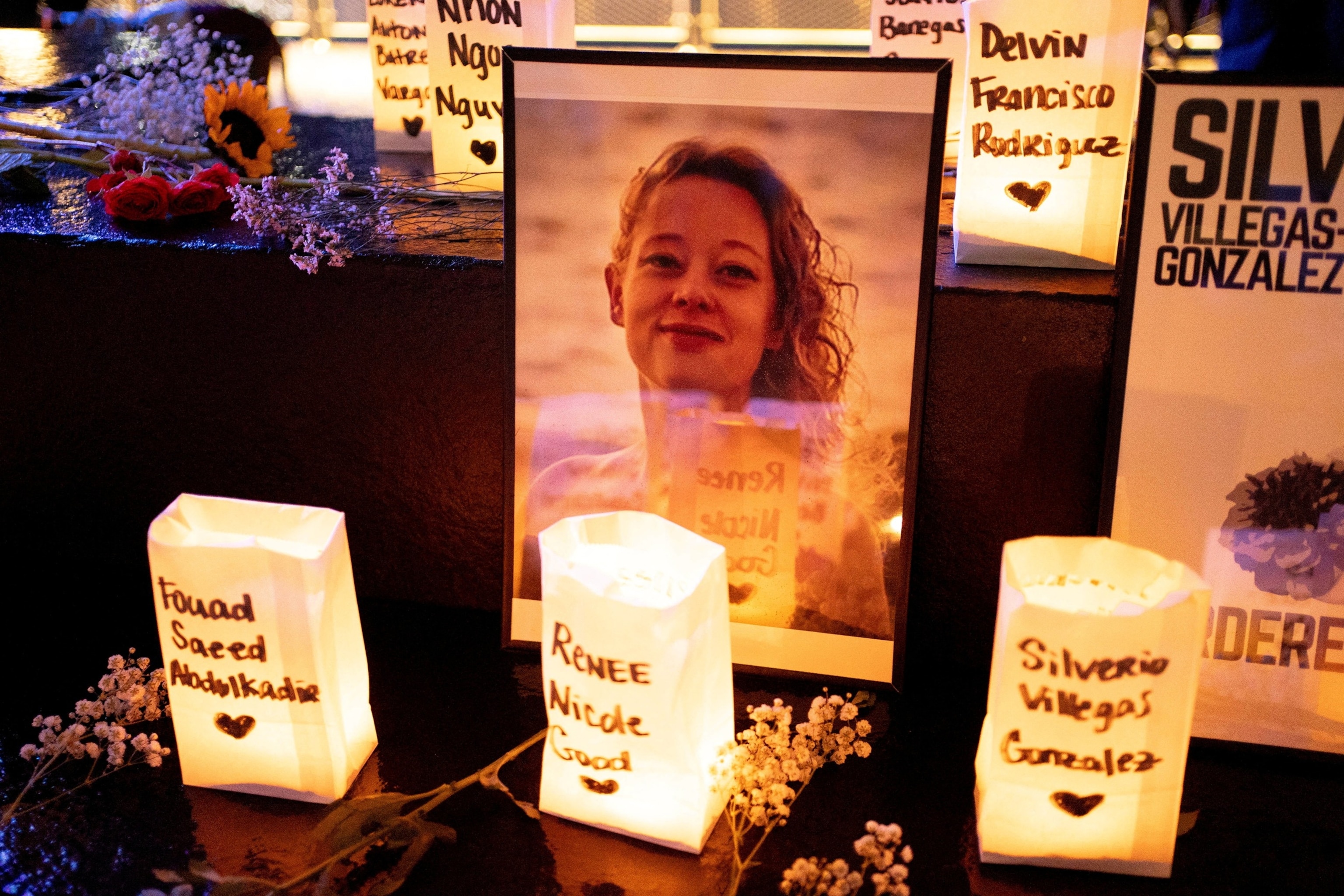 PHOTO: A photo of Renee Nicole Good, who was shot and killed by an ICE agent, sits near near candles bearing the names of people who have been killed by ICE agents or died in custody, during a vigil for her in Seattle, Jan. 8, 2026.