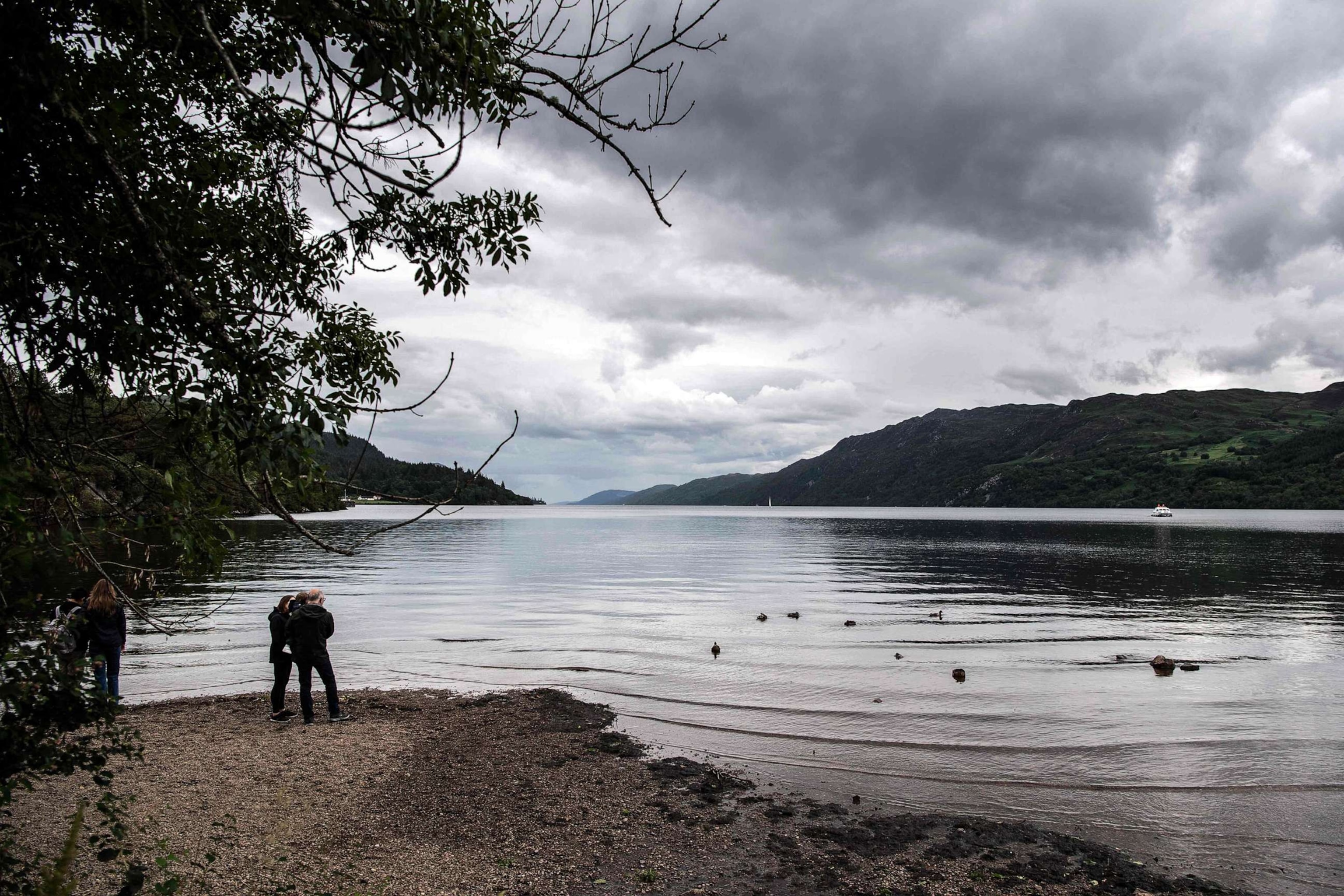 PHOTO: In this July 6, 2023, file photo, visitors look at the water of Loch Ness in the Scottish Highlands.