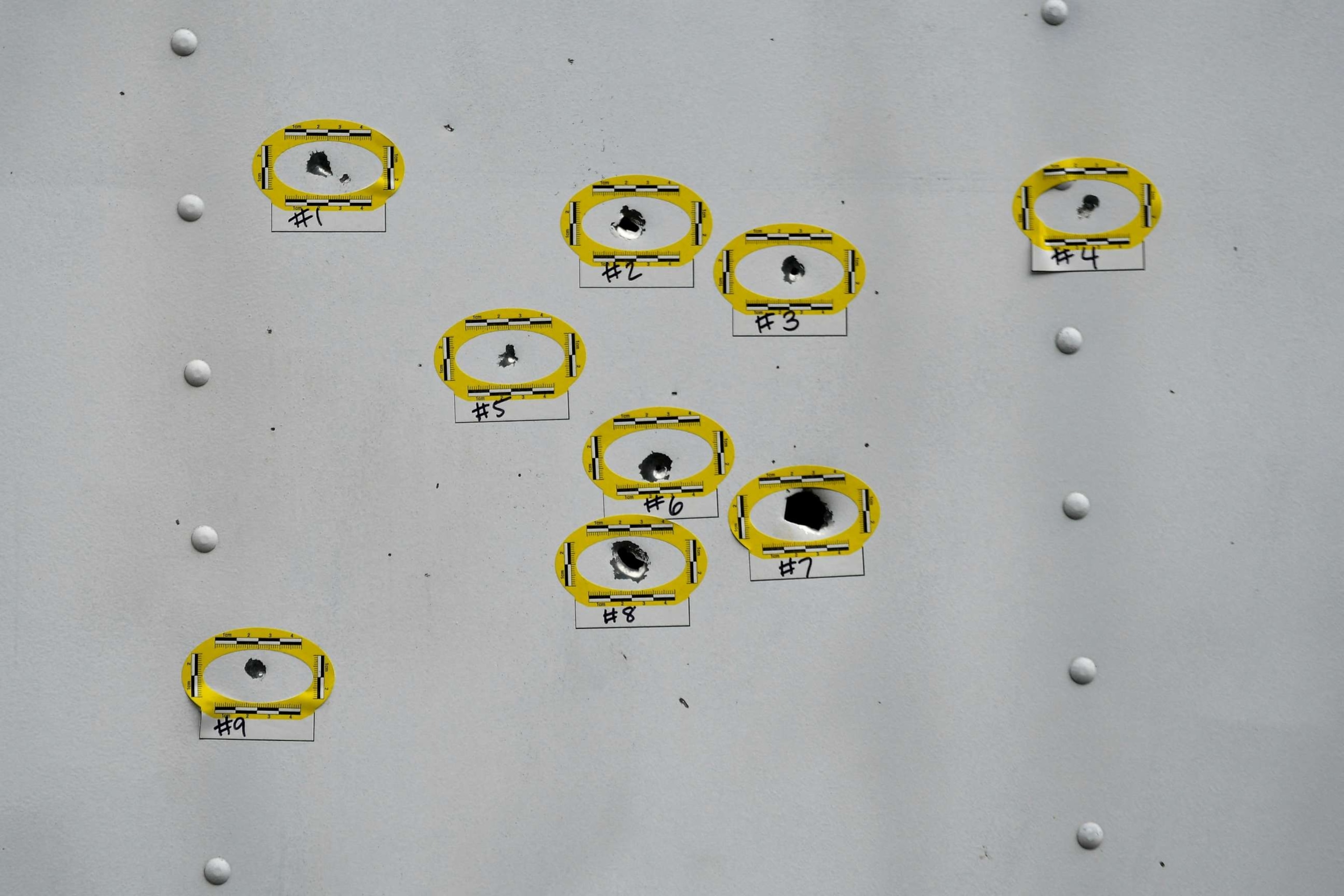 PHOTO: Bullet holes found on the side of a parked truck are marked as police officers work at the scene the day after a shooting in the Kingsessing section of southwest Philadelphia, July 4, 2023.