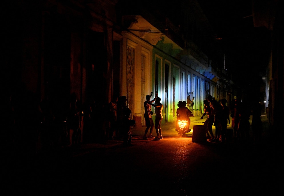 PHOTO: People gather on a street during a blackout as Cuba's national electric grid collapsed leaving around 10 million people without power  in Havana, Cuba March 16, 2026.