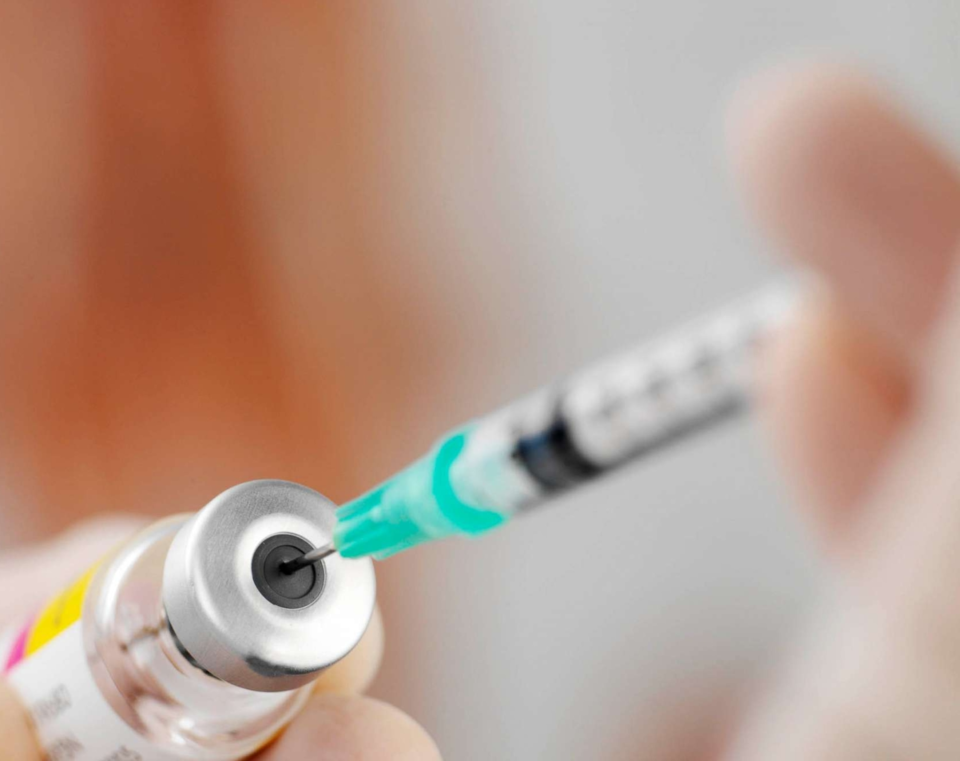 PHOTO: Syringe being filled. Drug or vaccine being drawn into a hypodermic syringe.Vaccination