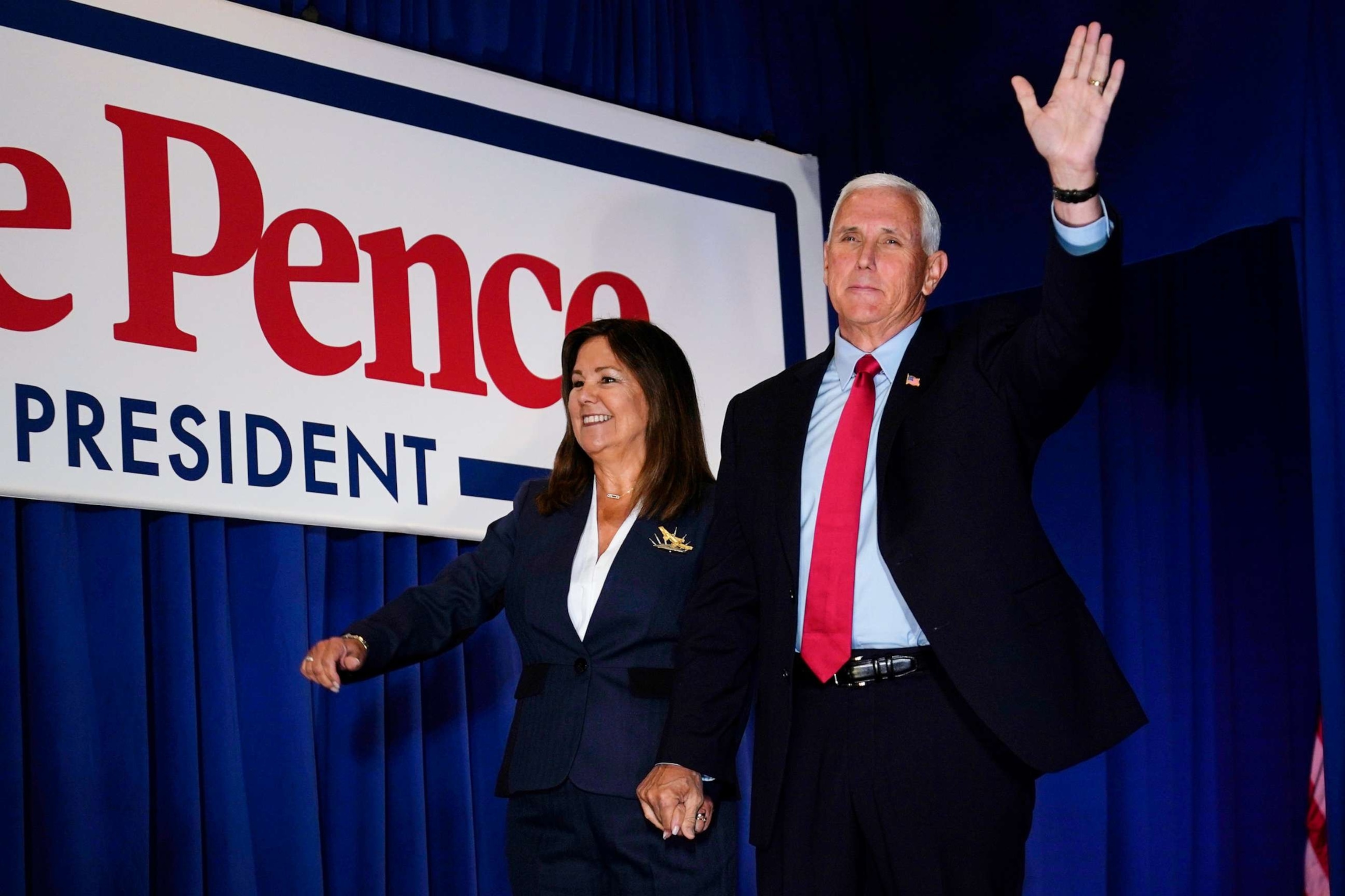 PHOTO: Republican presidential candidate and former Vice President Mike Pence waves while arriving at a campaign stop with his wife Karen on June 9, 2023, in Derry, N.H.