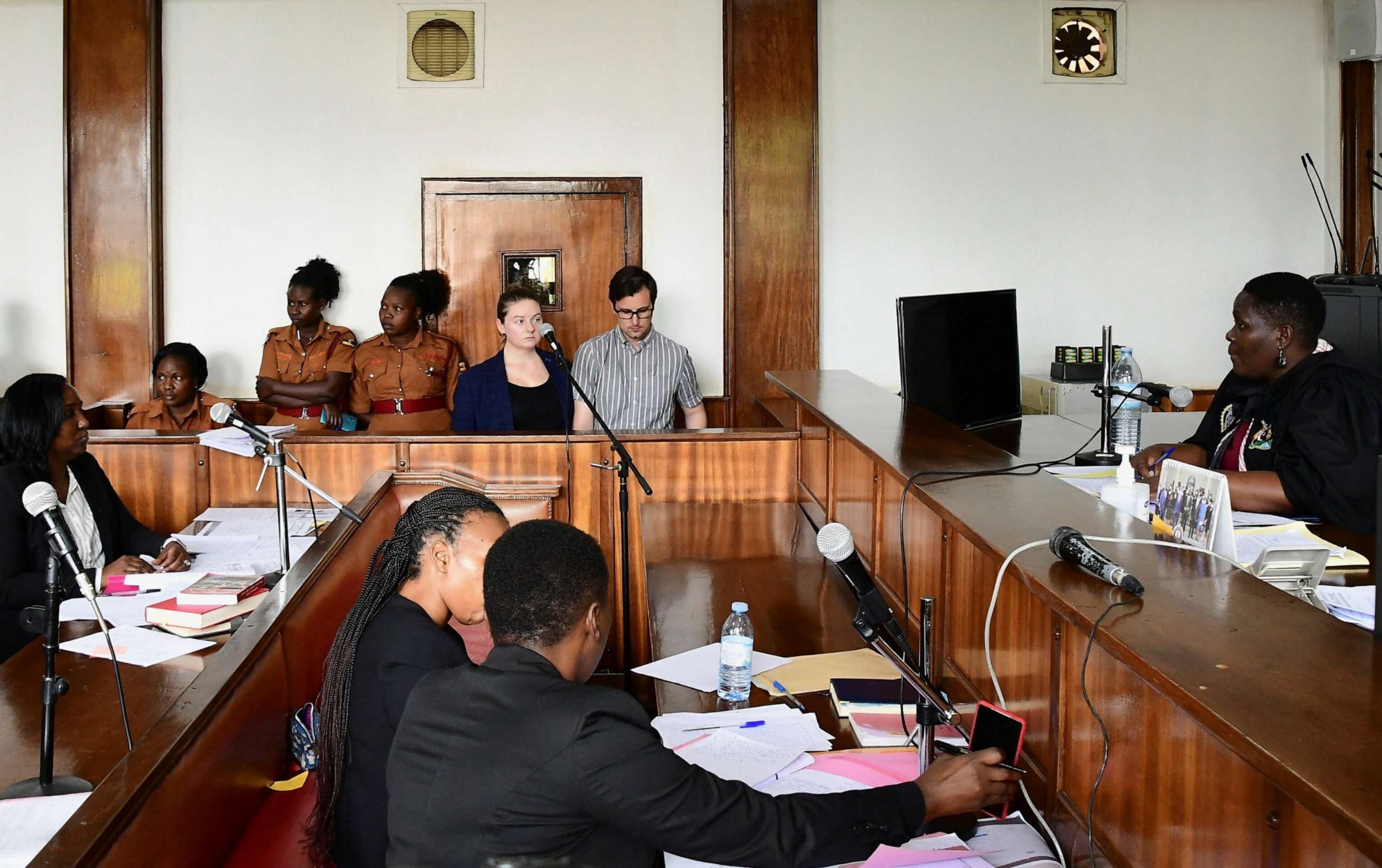 PHOTO: American couple Nicholas Spencer and Mackenzie Leigh Mathias Spencer, both 32, stand in the dock at Buganda road court, where they were charged with torturing a 10-year-old, in Kampala, Uganda, on Dec. 14, 2022.