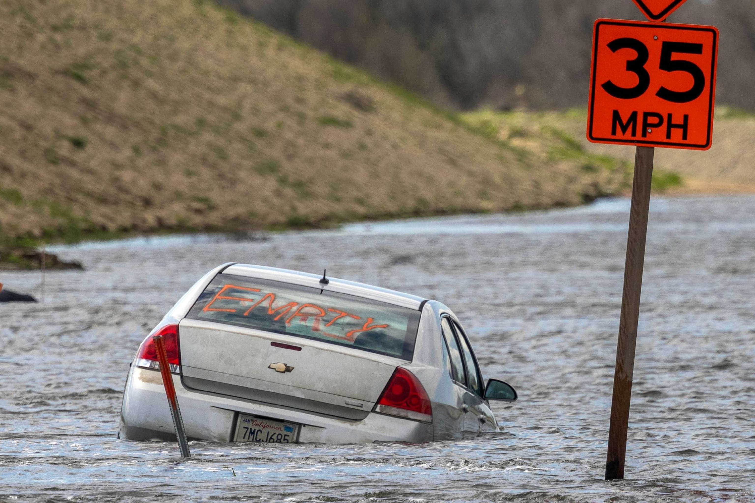 PHOTO: FILE - In an aerial view, a car is left stranded in widespread flooding as a series of atmospheric river storms melts record amounts of snow in the Sierra Nevada Mountains, March 23, 2023 near Corcoran, Calif.