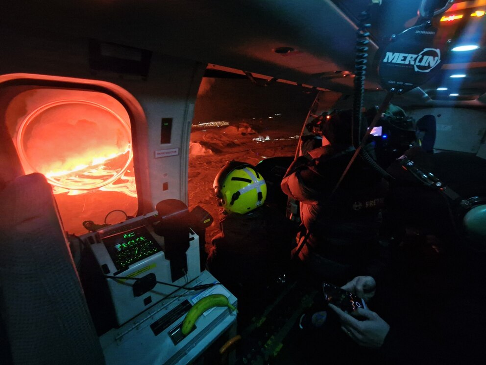 PHOTO: This handout picture released by the Icelandic Coast Guard on Feb. 8, 2024 shows a cameraman filming billowing smoke and flowing lava on the outskirts of the evacuated town of Grindavik, western Iceland.