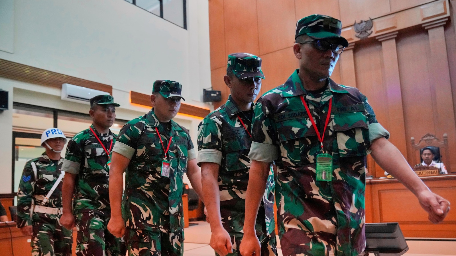 Trial begins for 4 Indonesian service members charged over acid attack on activist