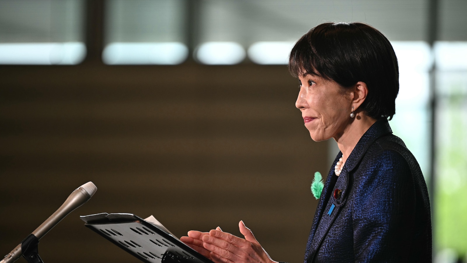 Japan's prime minister launches a panel to review her country's defense policies as threats escalate