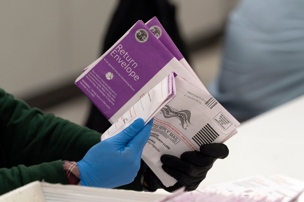 PHOTO: Workers check on signed signatures on mail-in voting ballots as they arrive at the new Los Angeles County Ballot Processing Center in the City of Industry, Calif.