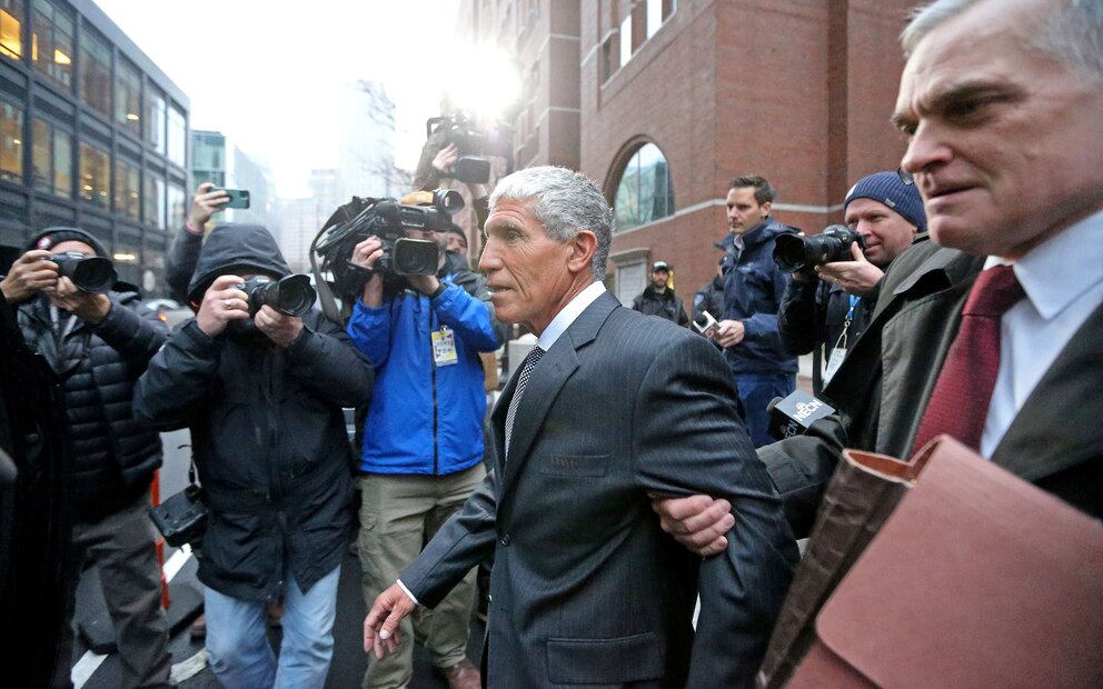 Varsity Blues mastermind William Rick Singer, center, leaves the Moakley Courthouse  after being sentenced to 3.5 years in prison January 4, 2023, in Boston, Mass.