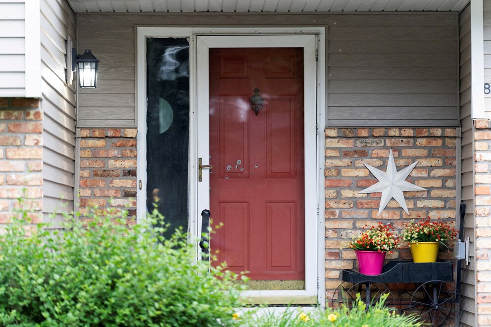 PHOTO: Bullet holes mark the front door of Minnesota state  Senator John Hoffman, who was shot alongside his wife, Yvette, in Champlin, Minnesota, U.S., June 14, 2025.
