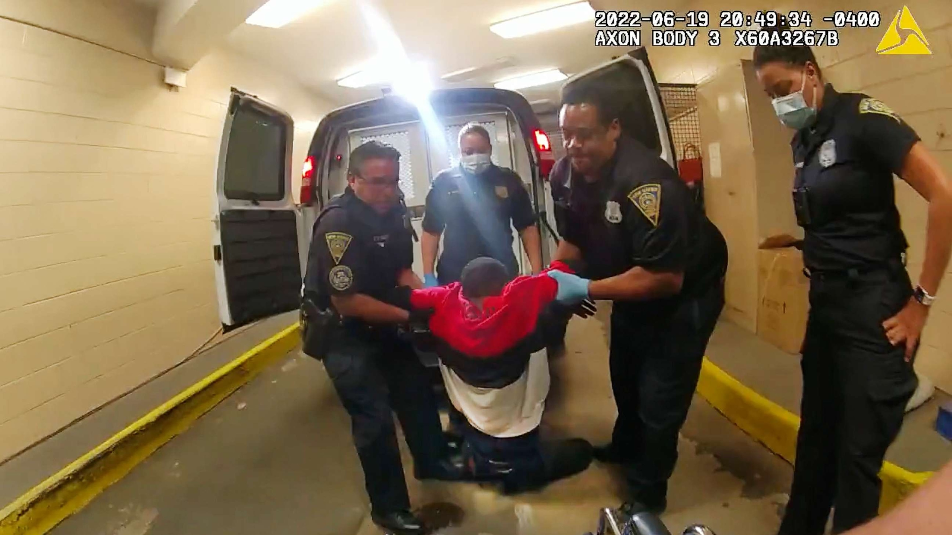 PHOTO: In this image taken from police body camera video provided by New Haven Police, Richard "Randy" Cox is pulled from the back of a police van and placed in a wheelchair after being detained by New Haven Police, June 19, 2022, in New Haven, Conn.