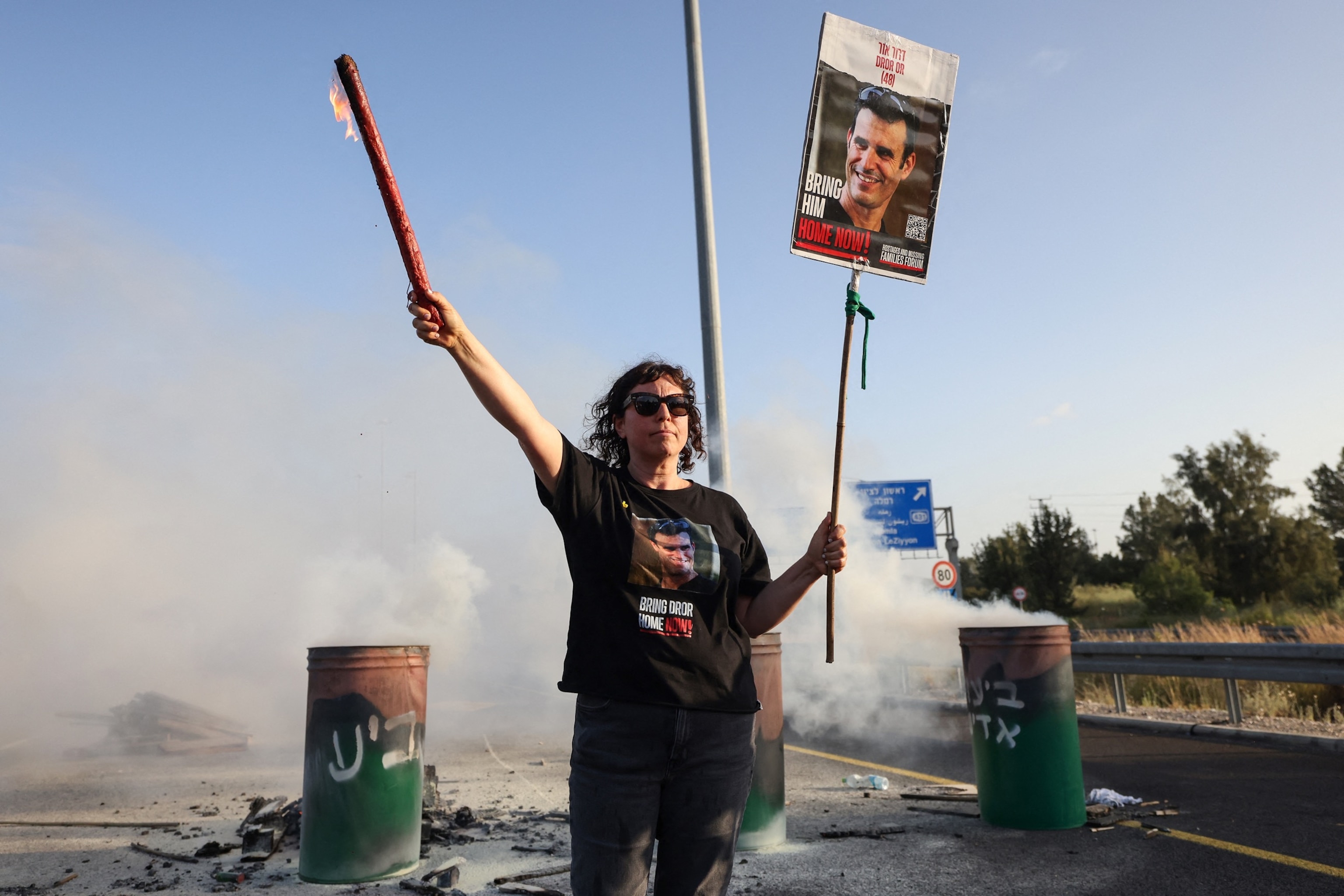 PHOTO: A woman holds a sign with a photograph of Israeli hostage Dror Or on April 19, 2024, during a protest calling for his release. 