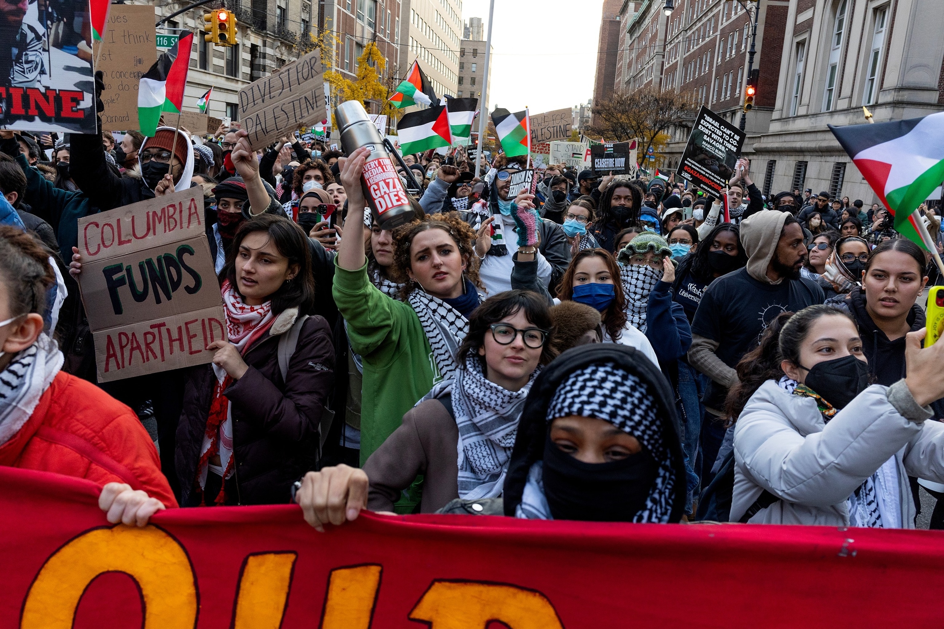PHOTO: Pro-Palestinian demonstrators march in solidarity with two Columbia University student groups which were recently banned from campus for their support of Palestine, Nov. 15, 2023, outside of the gates of Columbia University in New York.