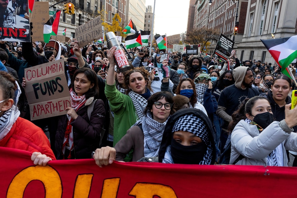 PHOTO: Pro-Palestinian demonstrators march in solidarity with two  Columbia University student groups which were recently banned from campus for their support of Palestine, Nov. 15, 2023, outside of the gates of Columbia University in New York.