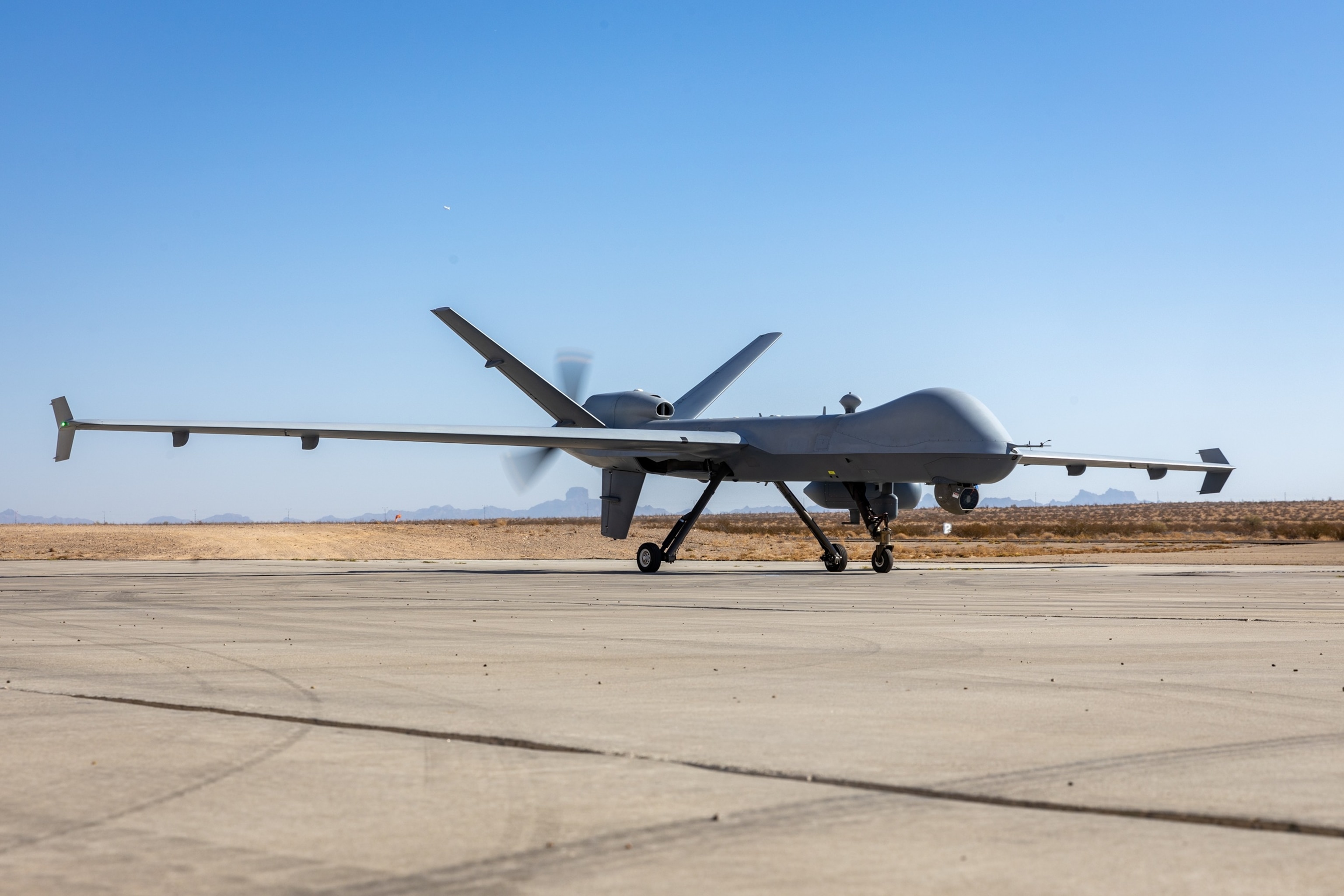 PHOTO: A Marine Corps MQ-9 Reaper drone prepares to take off for unmanned aerial system tactics training as part of Weapons and Tactics Instructor course 1-25 at Laguna Army Airfield, Arizona, Oct. 5, 2024. 
