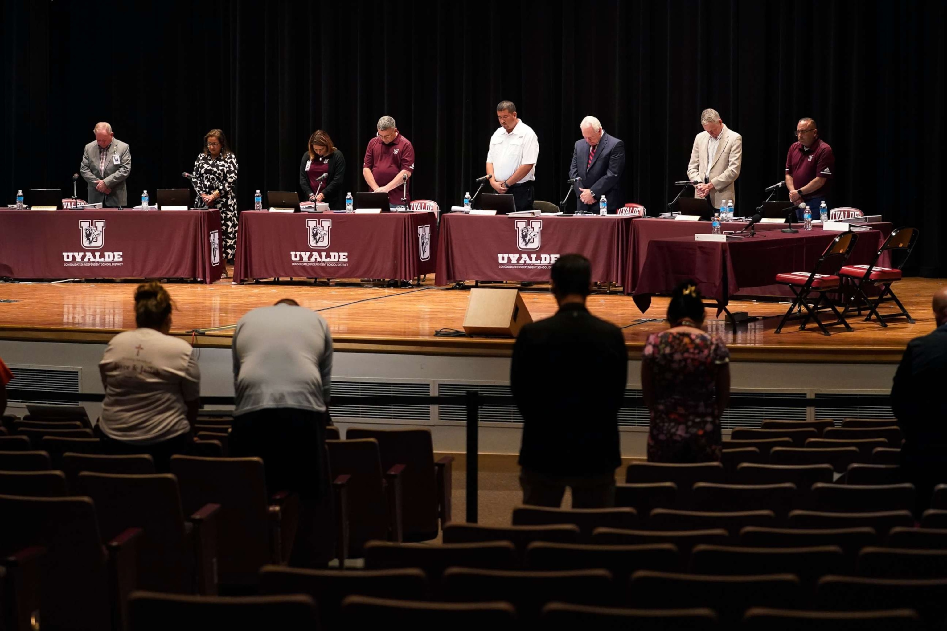 PHOTO: Attendees stand for a moment of silence before a termination hearing to decide the employment fate of Uvalde School District Police Chief Pete Arredondo in Uvalde, Texas, Aug. 24, 2022. 