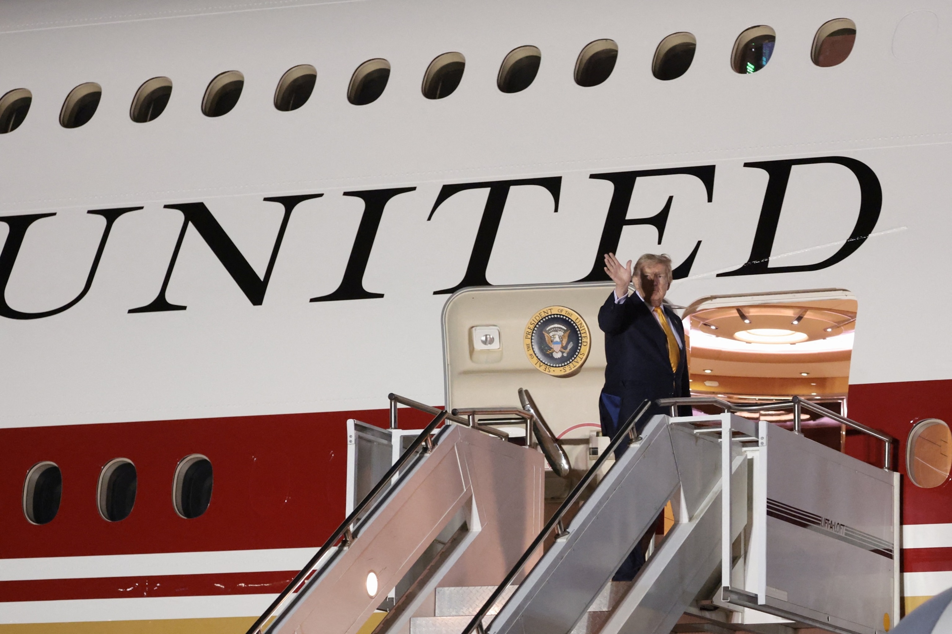 PHOTO: U.S. President Donald Trump boards the new, Qatari-gifted Air Force One after arriving on one of the older planes operating as Air Force One, to return to Washington, at RAF Mildenhall