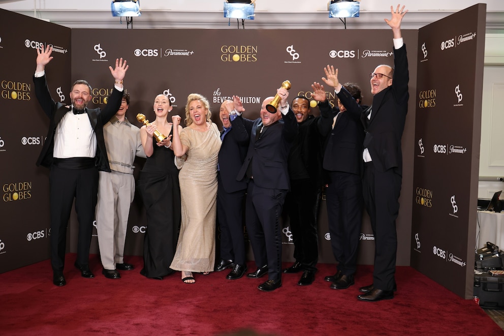 PHOTO: Philip Barantini, Owen Cooper, Erin Doherty, Hannah Walters, Stephen Graham, Mark Herbert, Ashley Walters, Jeremy Kleiner and Jack Thorne hold their Golden Globe Award for  "Adolescence" at the 2026 Golden Globes.