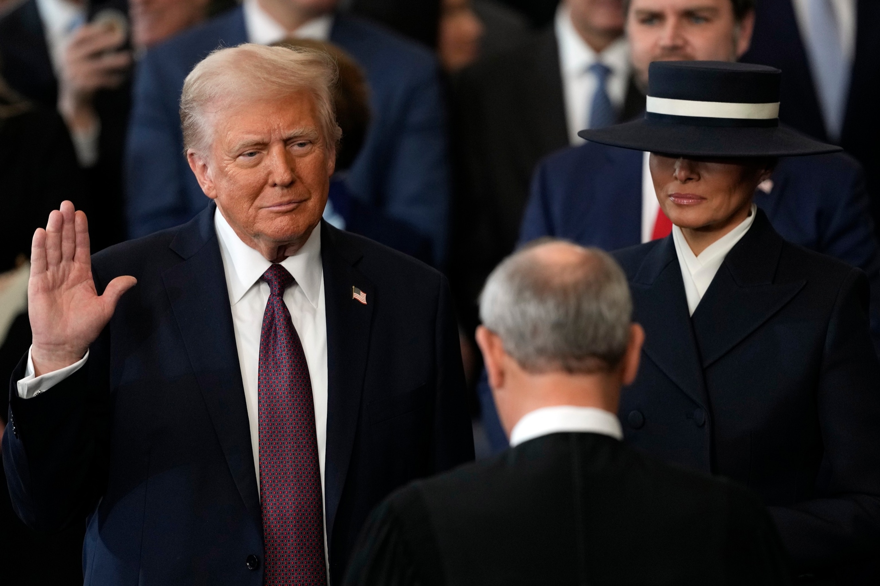 PHOTO: Donald Trump is sworn into office by Supreme Court Chief Justice John Roberts as Melania Trump holds the Bible in the Capitol Rotunda, Jan. 20, 2025, in Washington, D.C. 