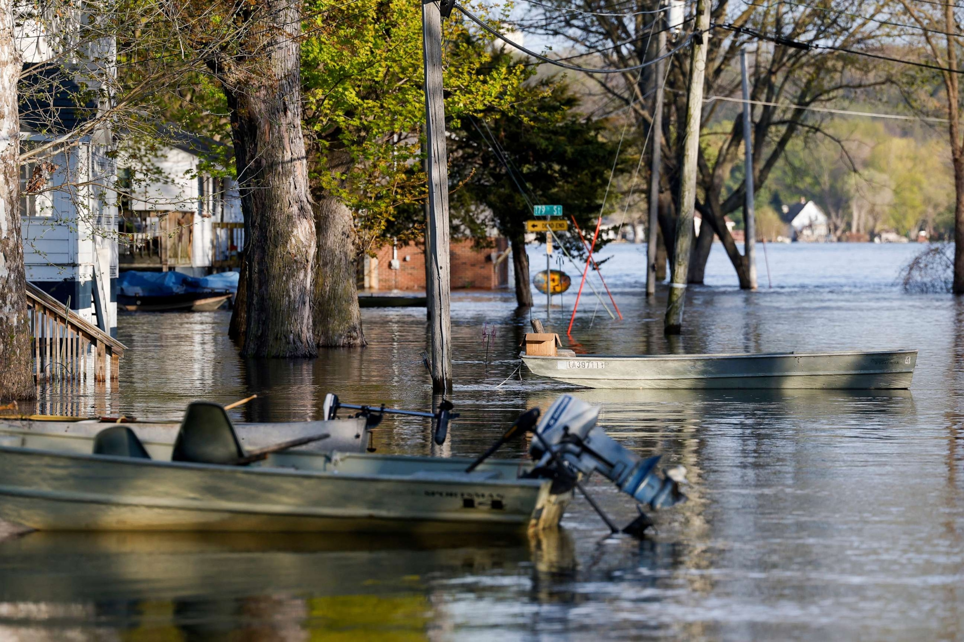 PHOTO: Boats float tethered in the front yards of homes as the Mississippi River continues to rise, forcing residents to find alternative means of transportation, April 27, 2023, in Pleasant Valley, Iowa.