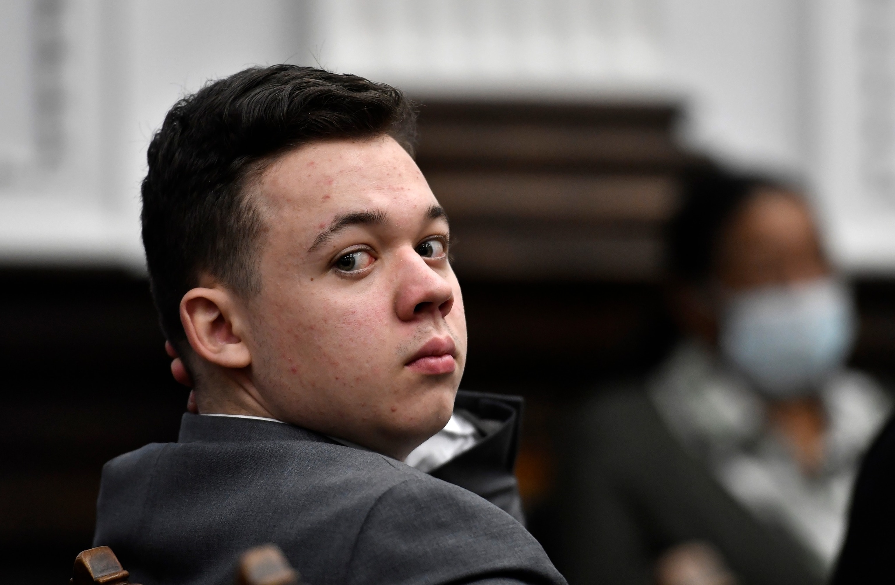 PHOTO: Kyle Rittenhouse looks back as attorneys argue about the charges that will be presented to the jury during proceedings at the Kenosha County Courthouse in Kenosha, Wis., in this Nov. 12, 2021, file photo. 