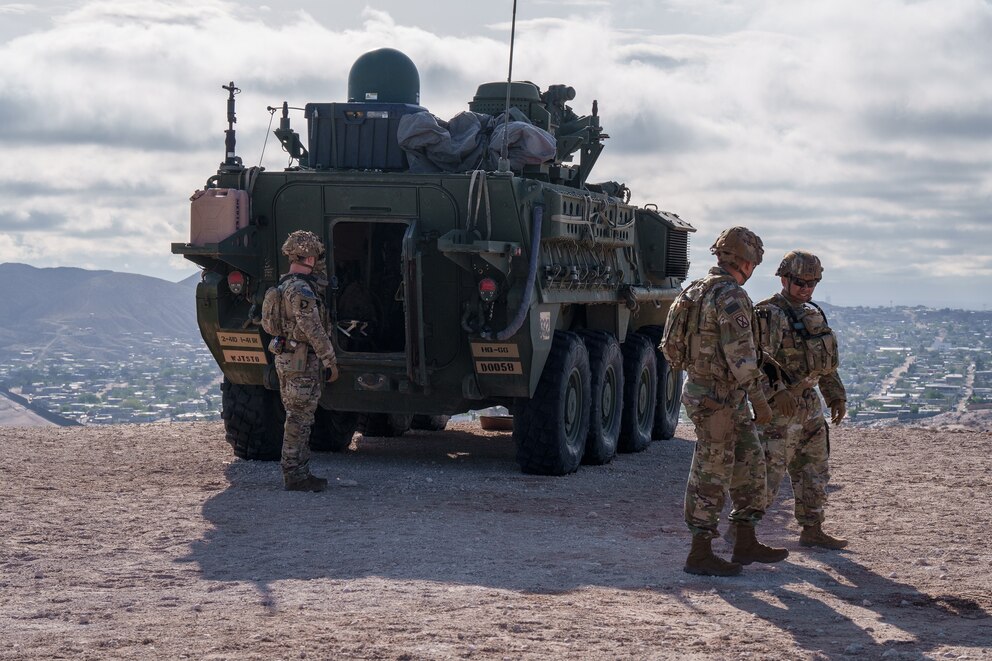 PHOTO: U.S. Army soldiers stand outside of a Stryker armored infantry