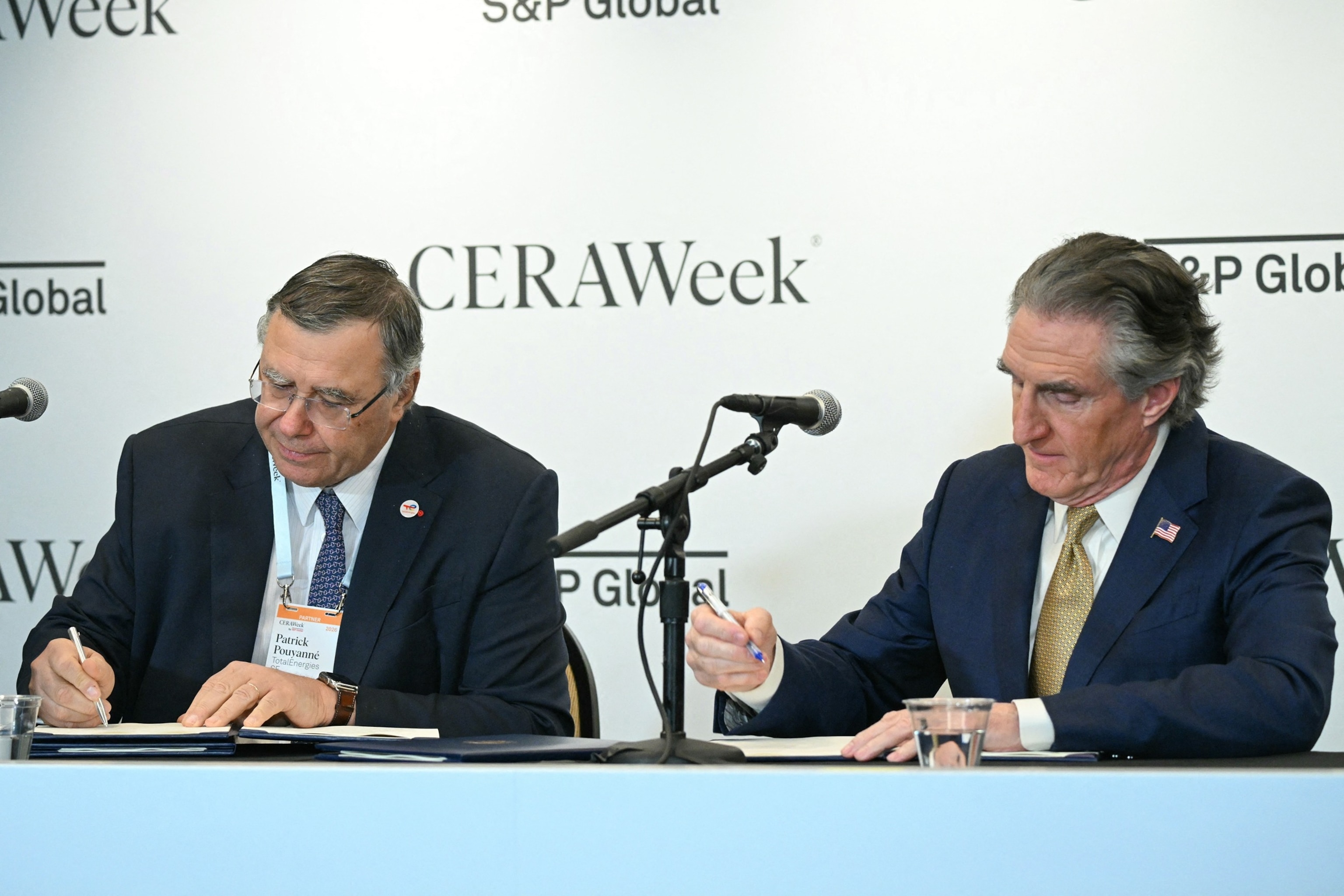 PHOTO: Patrick Pouyanne, CEO of TotalEnergies SE, and Secretary of the Interior Doug Burgum sign an agreement during 2026 CERAWeek by S&P Global energy conference in Houston, Texas on March 23, 2026.