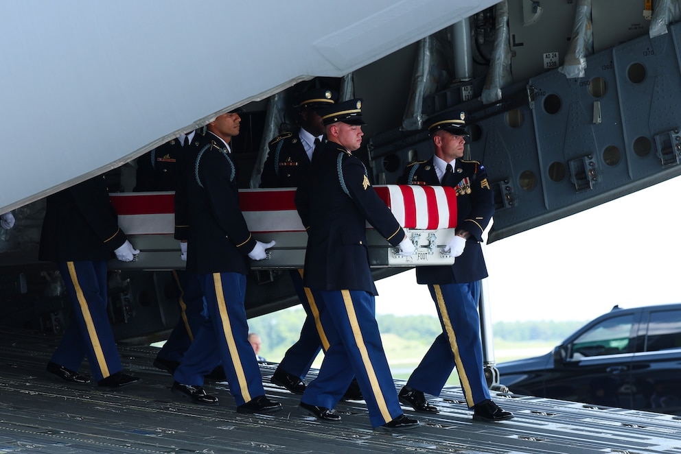 PHOTO: Members of a U.S. Army carry team move the flag-draped transfer case holding the remains of Army Staff Sgt. Michael Emmanuel Swinton of Fayetteville, during a dignified transfer at Dover Air Force Base July 22, 2026 in Dover, Delaware.