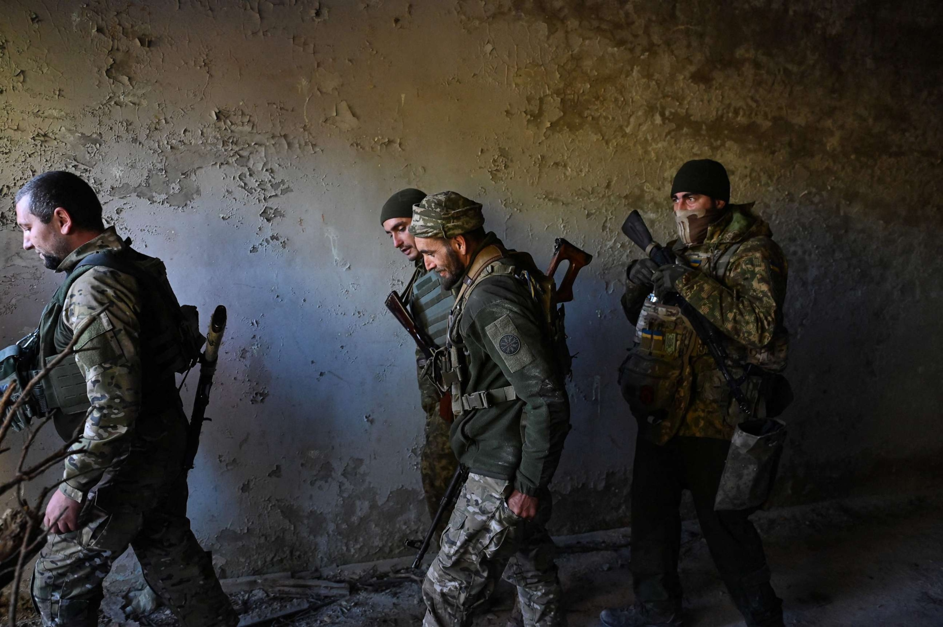 PHOTO: Servicemen of Ukrainian first presidential brigade "Bureviy" walk together after taking part in military exercises in the Chernihiv region on Oct. 13, 2023, before deployment on the front line, amid the Russian invasion in Ukraine.