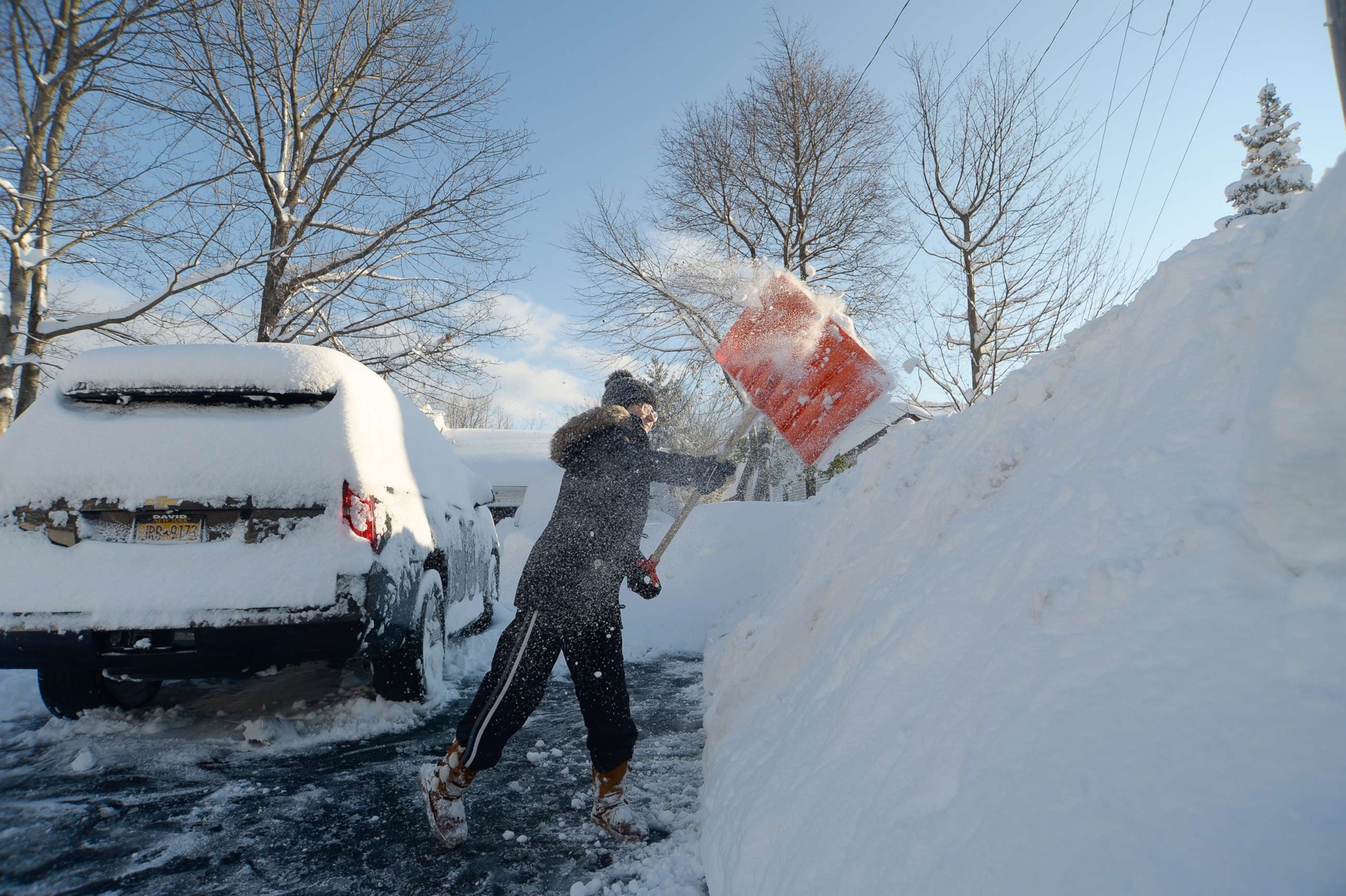 PHOTO: Heather Ahmed digs out after an intense lake-effect snowstorm impacted the area on Nov. 19, 2022, in Hamburg, N.Y.