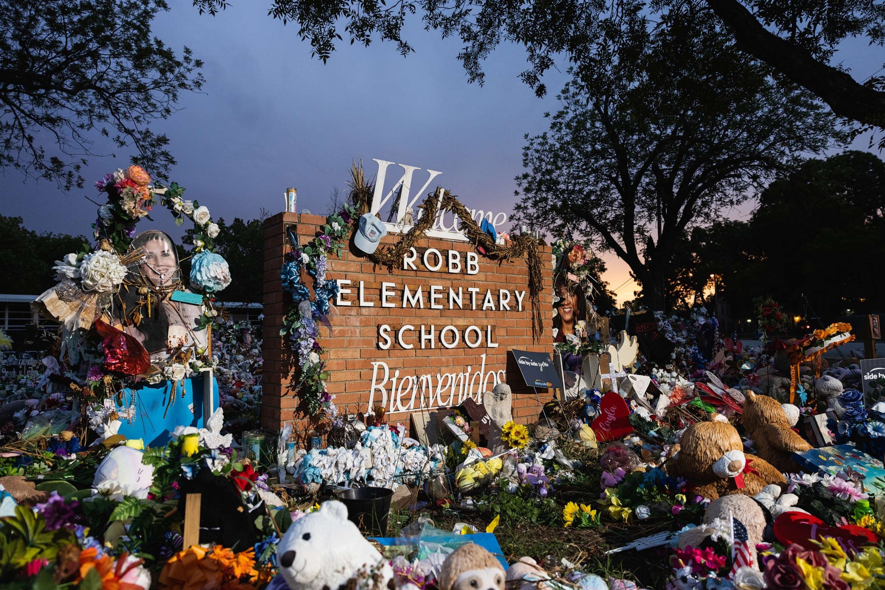 PHOTO: The sun sets behind the memorial for the victims of the massacre at Robb Elementary School, 24, 2022, in Uvalde, Texas.