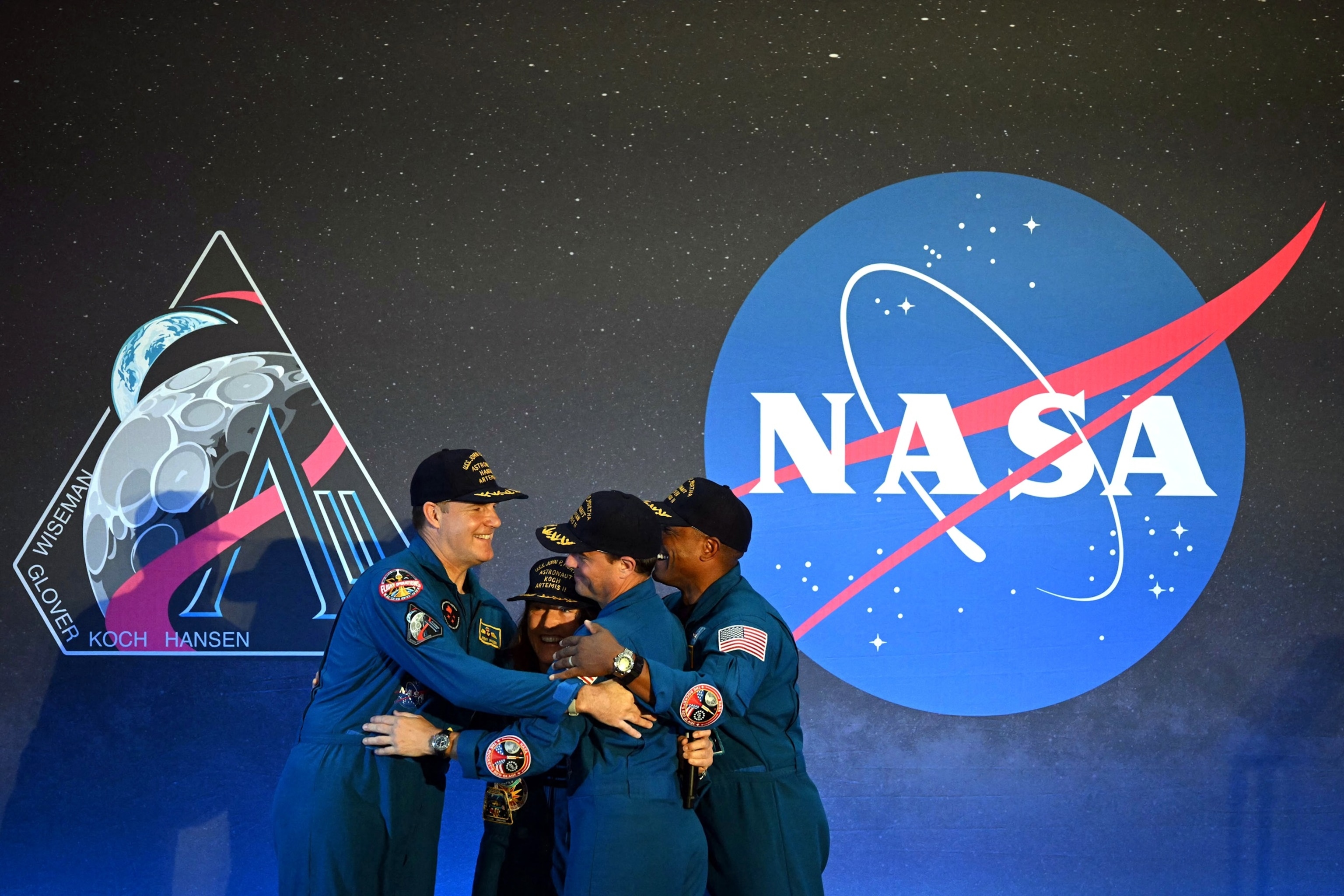 PHOTO: (L-R) NASA's Artemis II mission astronauts Canadian Space Agency's mission specialist Jeremy Hansen, mission specialist Christina Koch, commander Reid Wiseman and pilot Victor Glover share a hug in Houston, Texas, on April 11, 2026. 